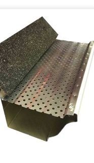 Gutter guard section showing a perforated metal screen and a granular surface, likely for debris filtration.