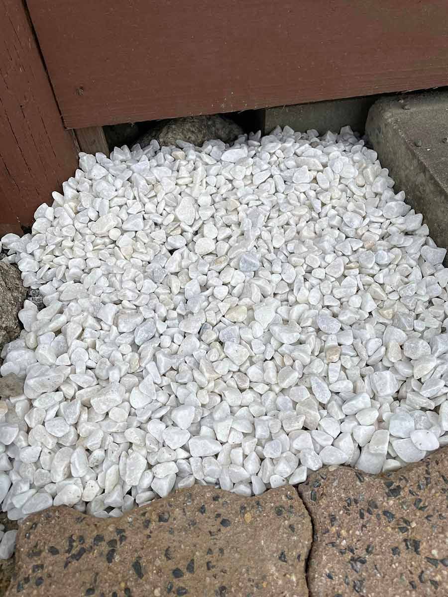 A Pile Of White Gravel Is Sitting On Top Of A Brick Sidewalk — Zappala Raw Materials Pty Ltd In Edmonton, QLD