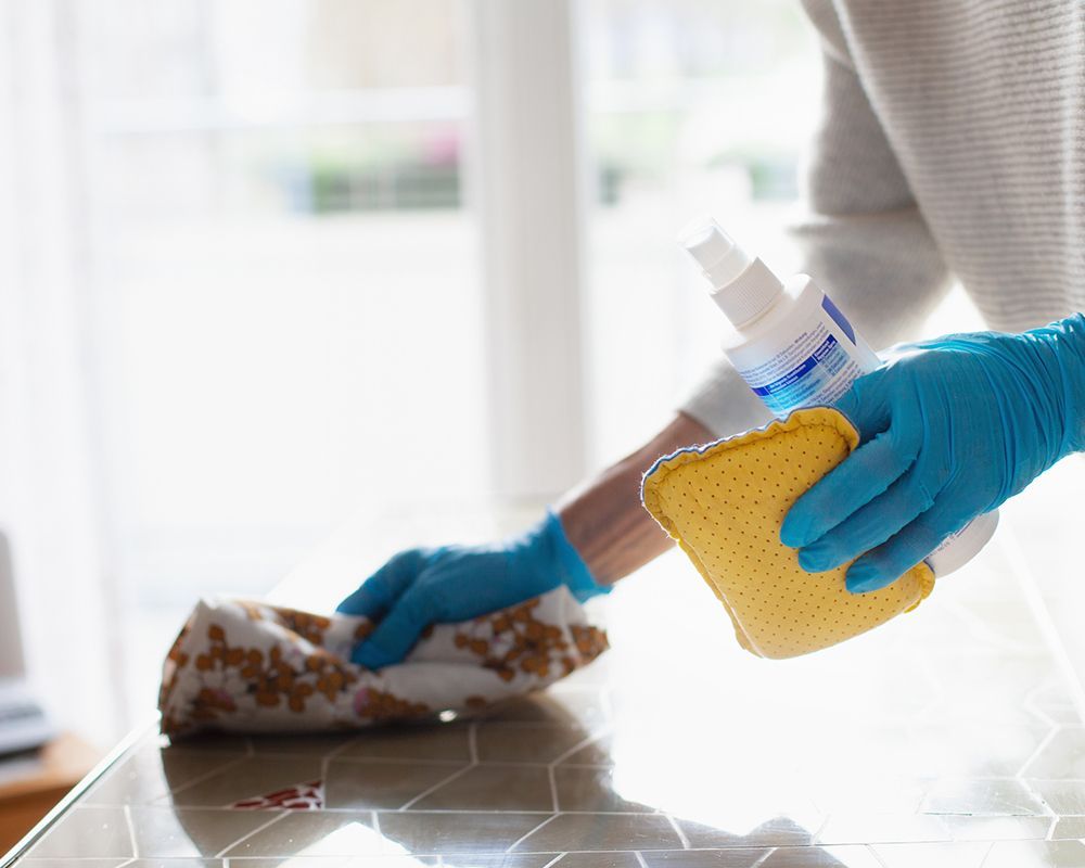 Woman Cleaning Table — Danbury, CT — J & P Cleaning Service
