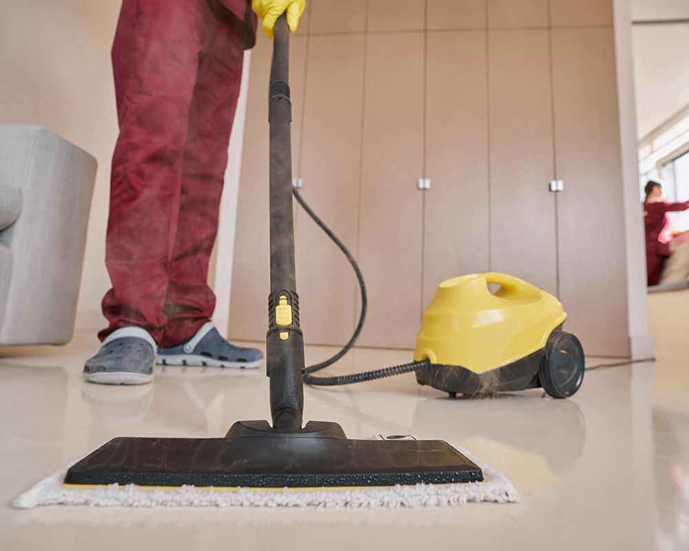 Worker Using Steam-Cleaning Equipment — Danbury, CT — J & P Cleaning Service