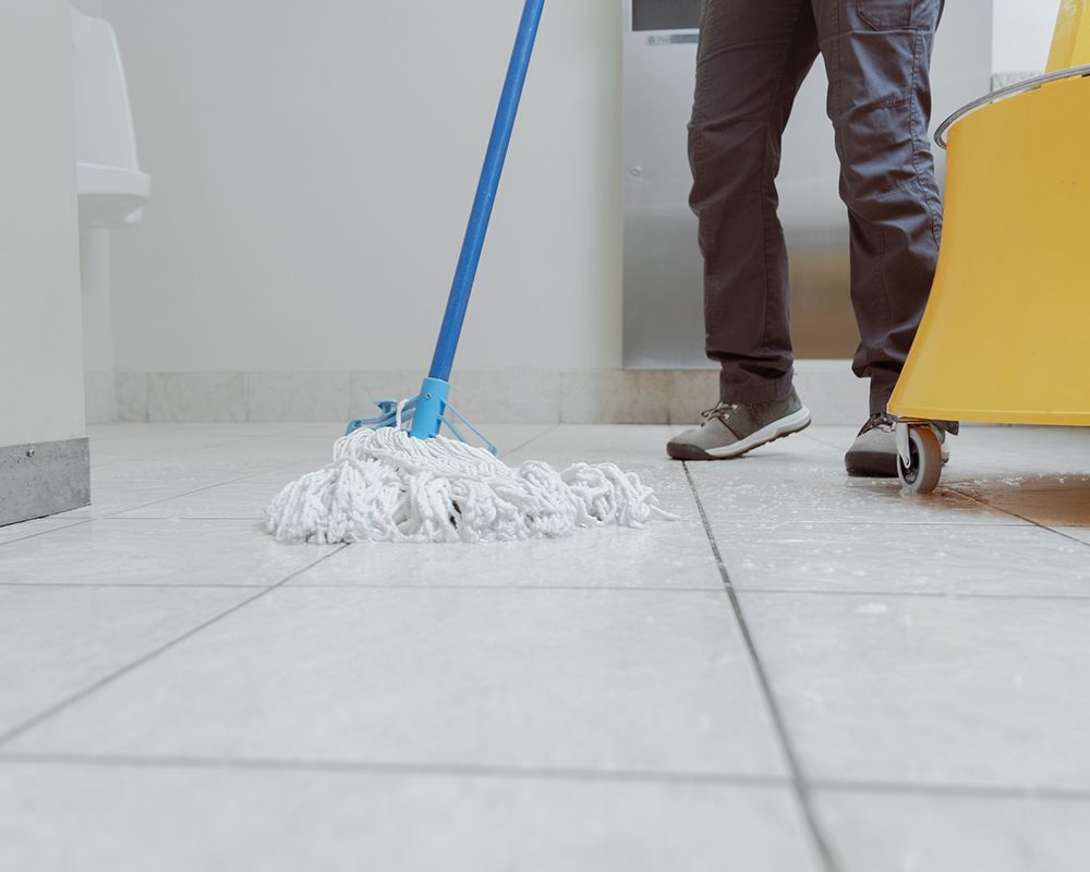 Worker Mopping Office Restroom — Danbury, CT — J & P Cleaning Service