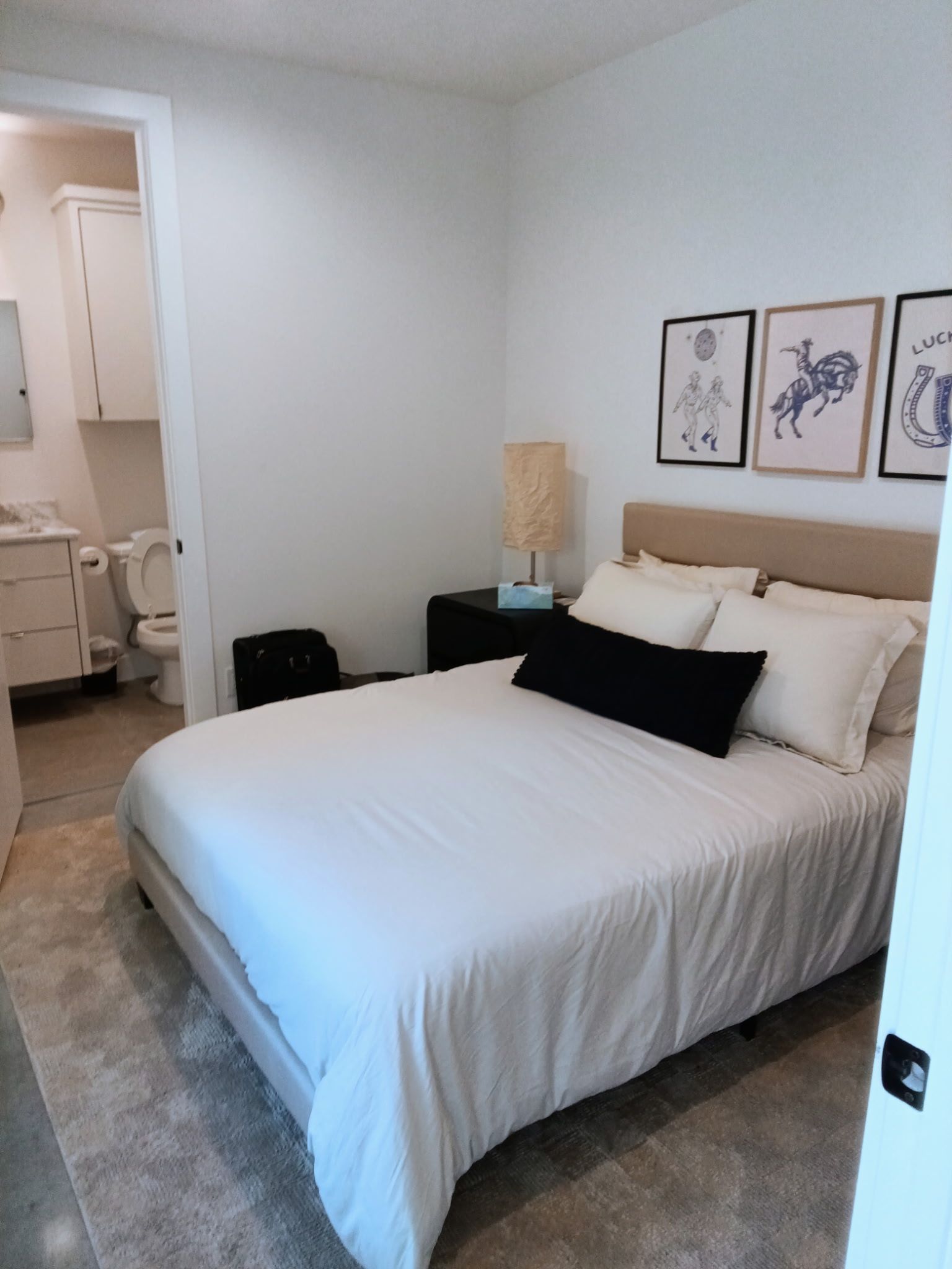 Living room with beige couches, wooden coffee table, and area rug on a wood floor.