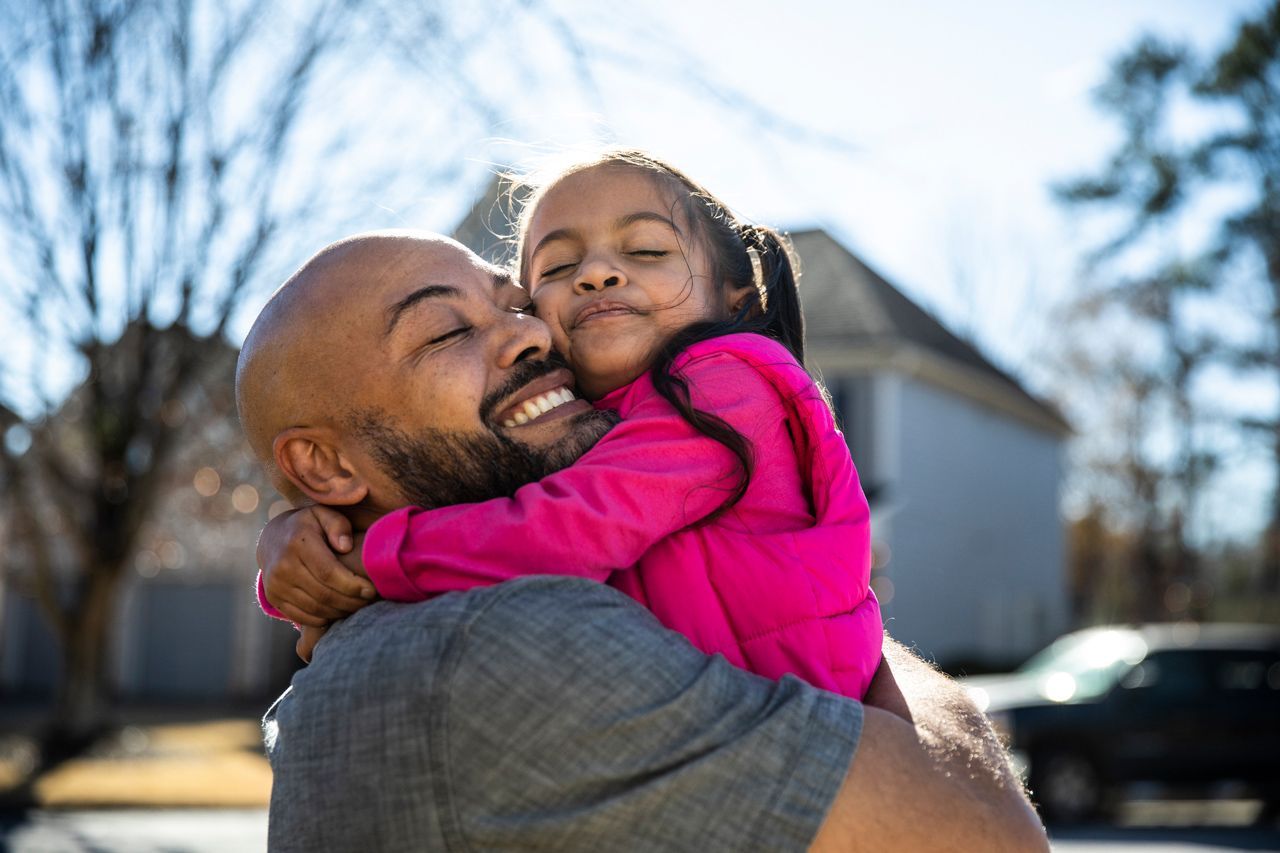 Father hugging his daughter.