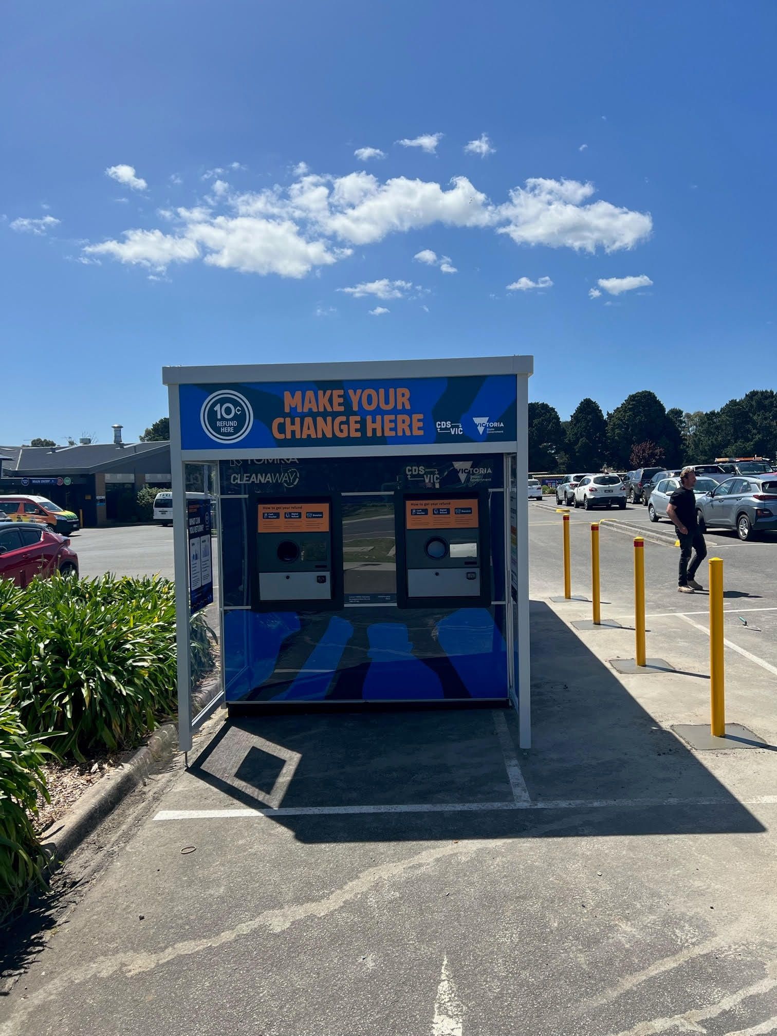 A kiosk in a parking lot that says make your change here