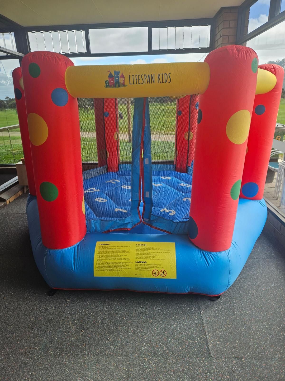 a bouncy house that says lifespan kids on it