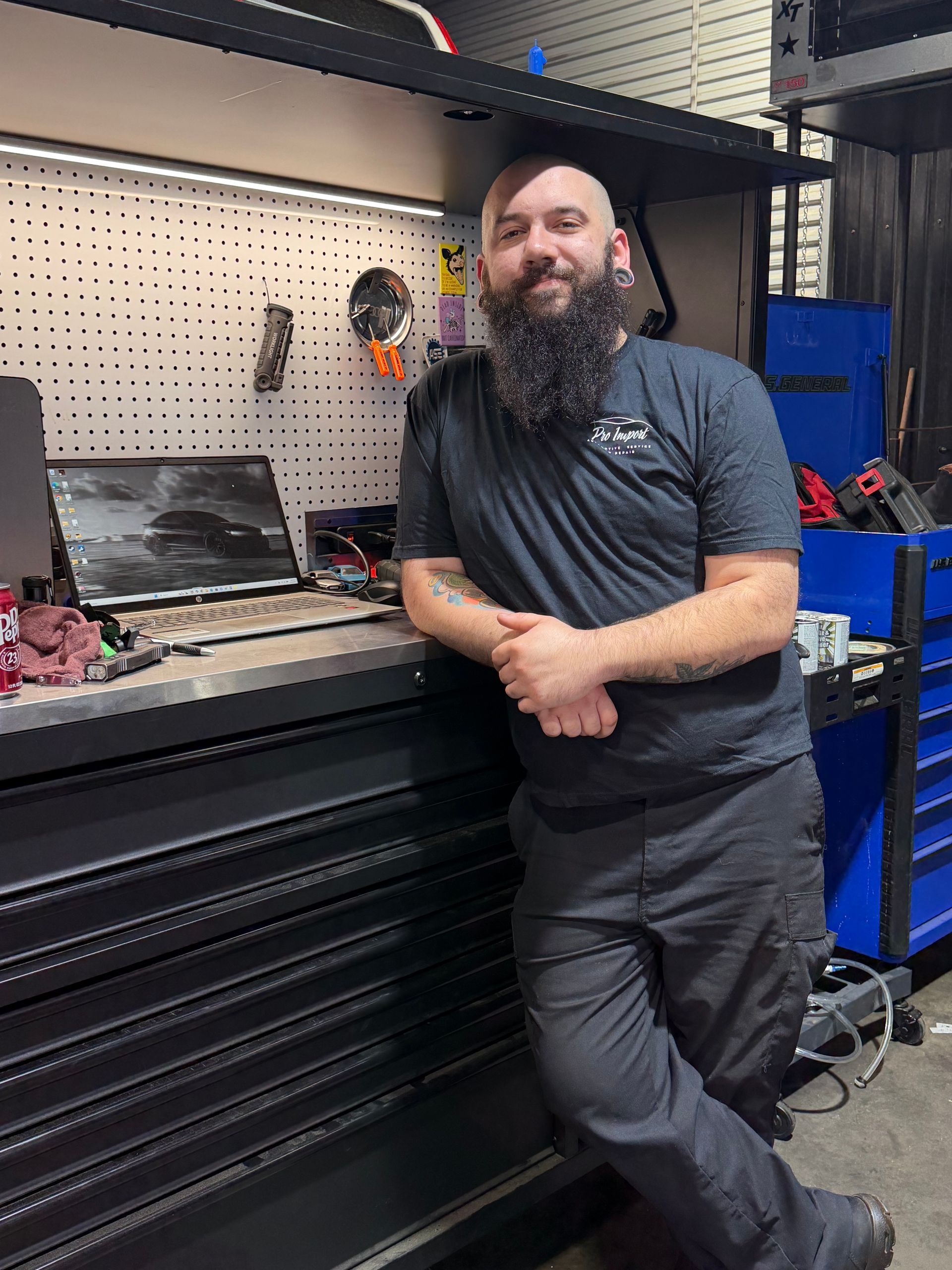 A person wearing a dark blue, ribbed long-sleeved shirt. | Pro Import Automotive Service and Repair