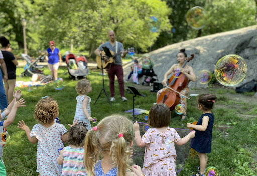 Sara Sherman playing music for children outside