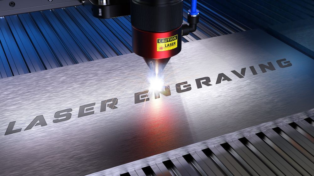 A Machine Is Engraving the Word Laser on A Piece of Metal — Jimani Trophies & Engraving in Dapto, NSW
