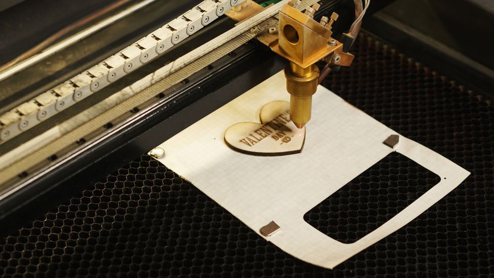 A Machine Is Cutting a Piece of Paper with The Letter D on It — Jimani Trophies & Engraving in Dapto, NSW