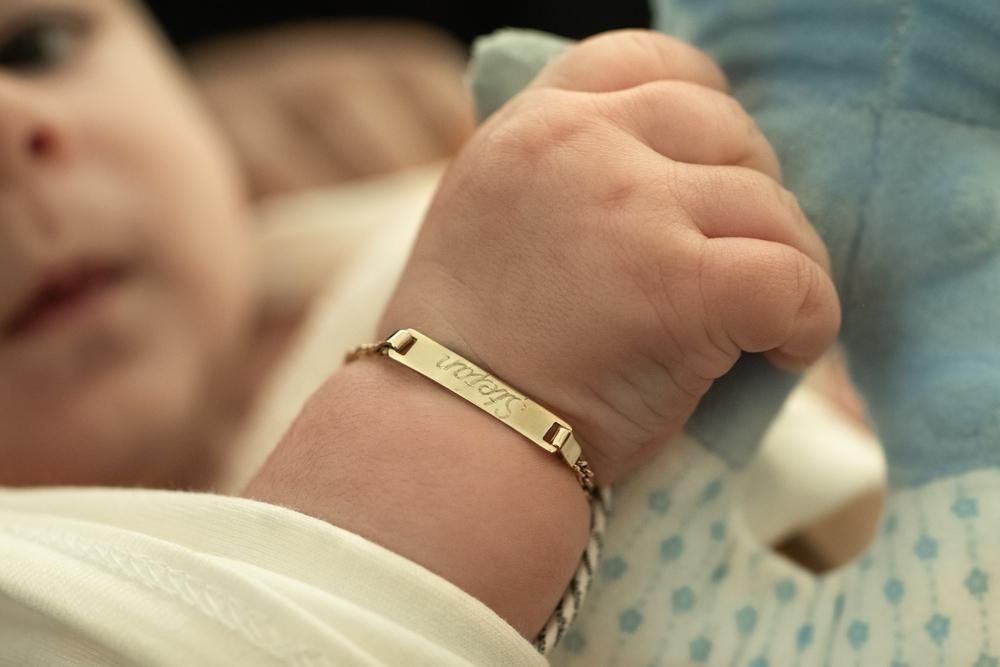 A Baby Wearing a Bracelet With the Name Joseph on It — Jimani Trophies & Engraving In Dapto, NSW