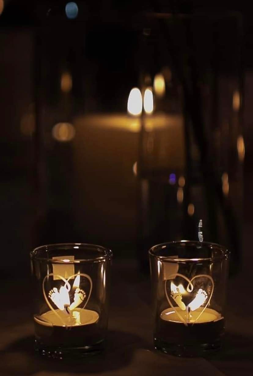 Two Candles in Glasses With Hearts on Them Are Lit Up in the Dark — Jimani Trophies & Engraving In Dapto, NSW