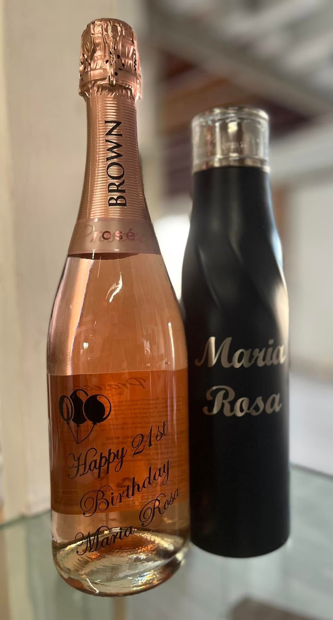 A Bottle of Champagne and a Bottle of Water Are on a Table — Jimani Trophies & Engraving In Dapto, NSW