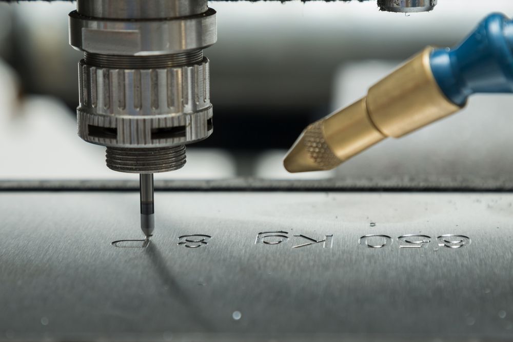 A Close up Of a Machine Cutting a Piece of Metal — Jimani Trophies & Engraving in Dapto, NSW