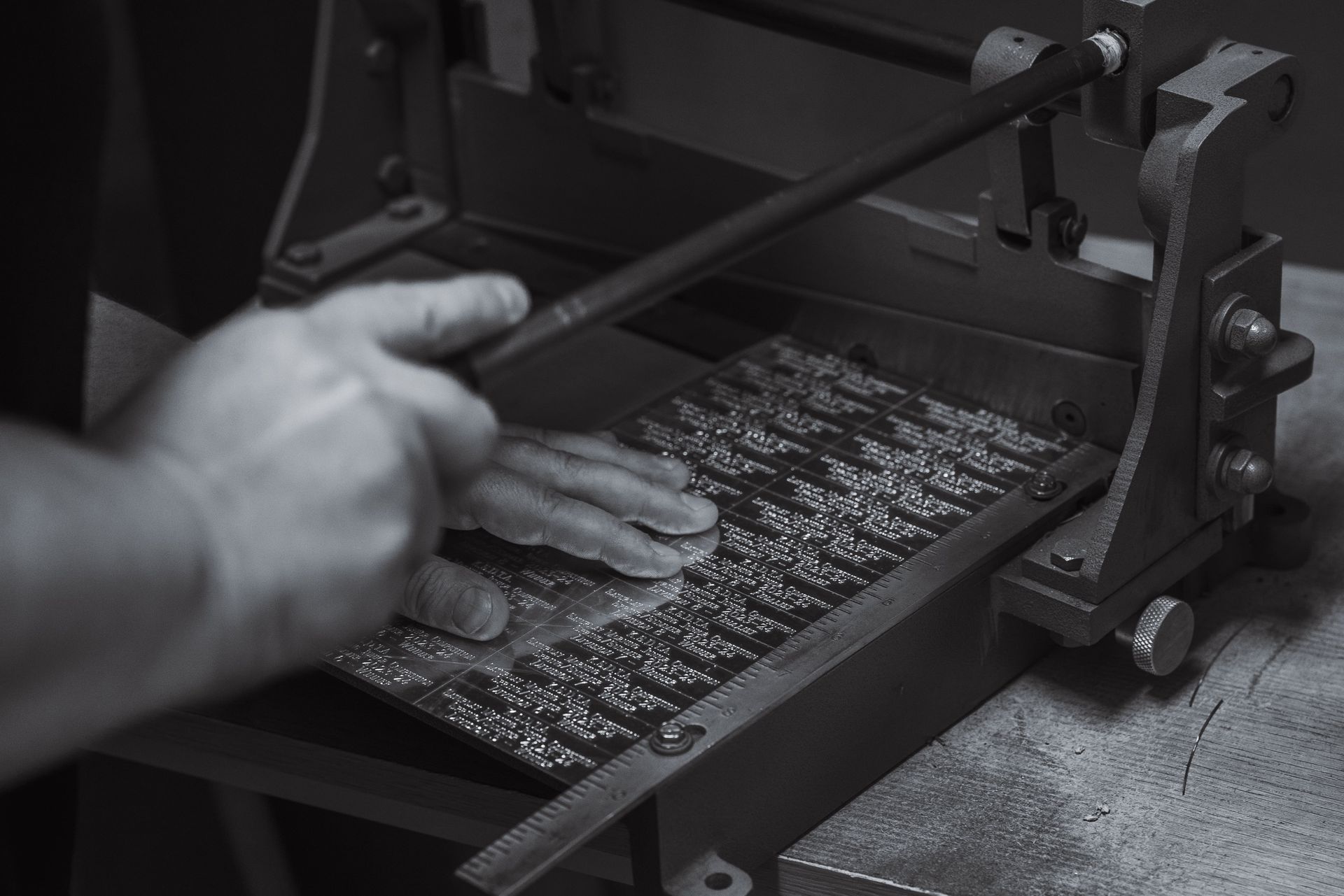 A Black and White Photo of a Person Using a Machine — Jimani Trophies & Engraving In Dapto, NSW