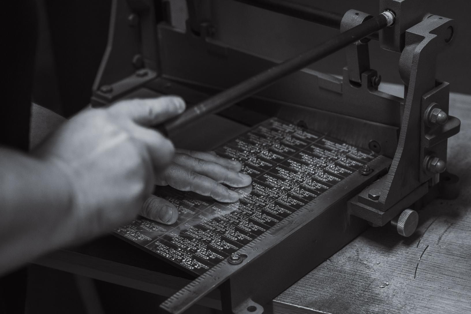A Black and White Photo of A Person Using a Machine — Jimani Trophies & Engraving In Dapto, NSW