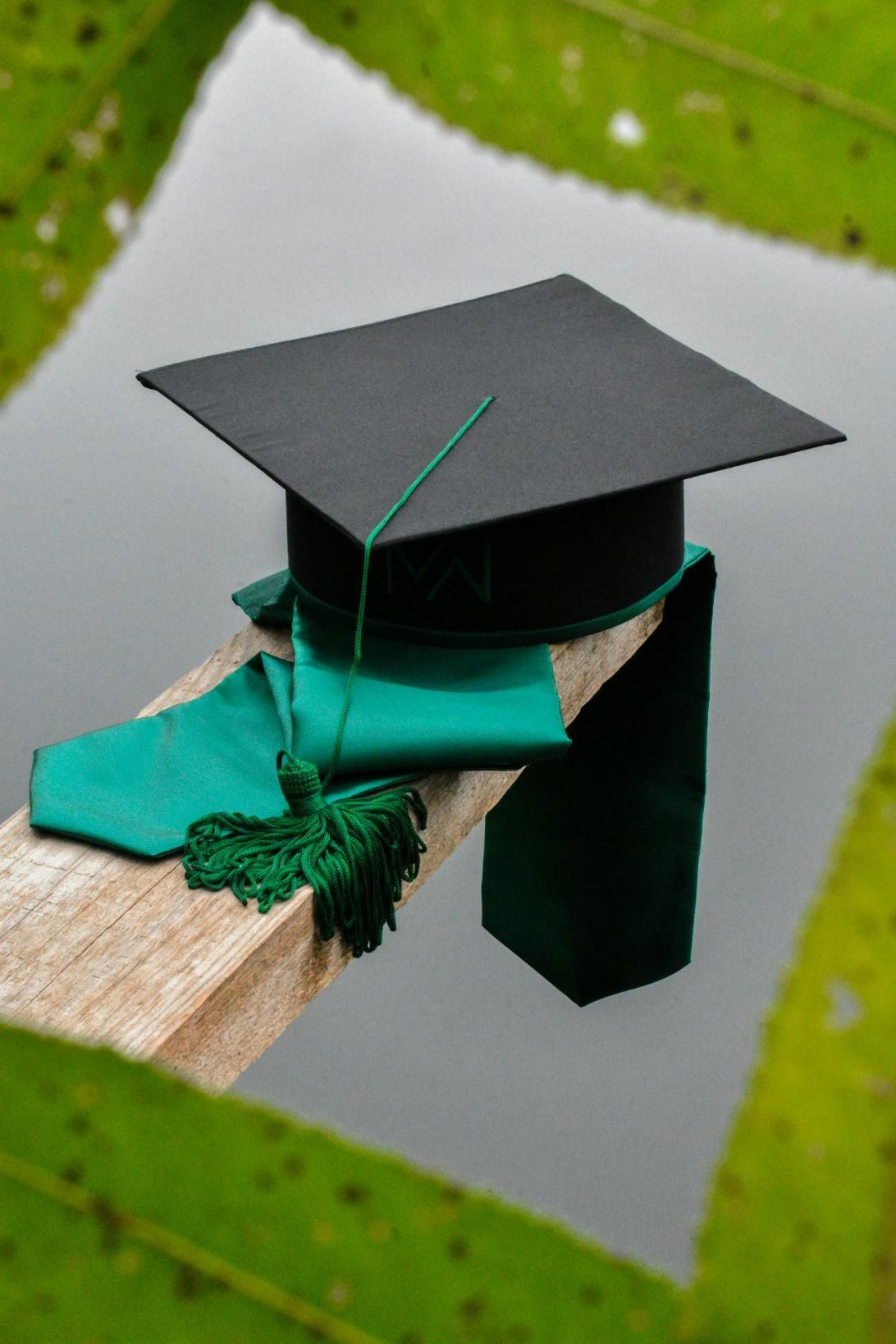 Graduation Cap And Green Ribbon On A Wood — Jimani Trophies & Engraving In Dapto, NSW