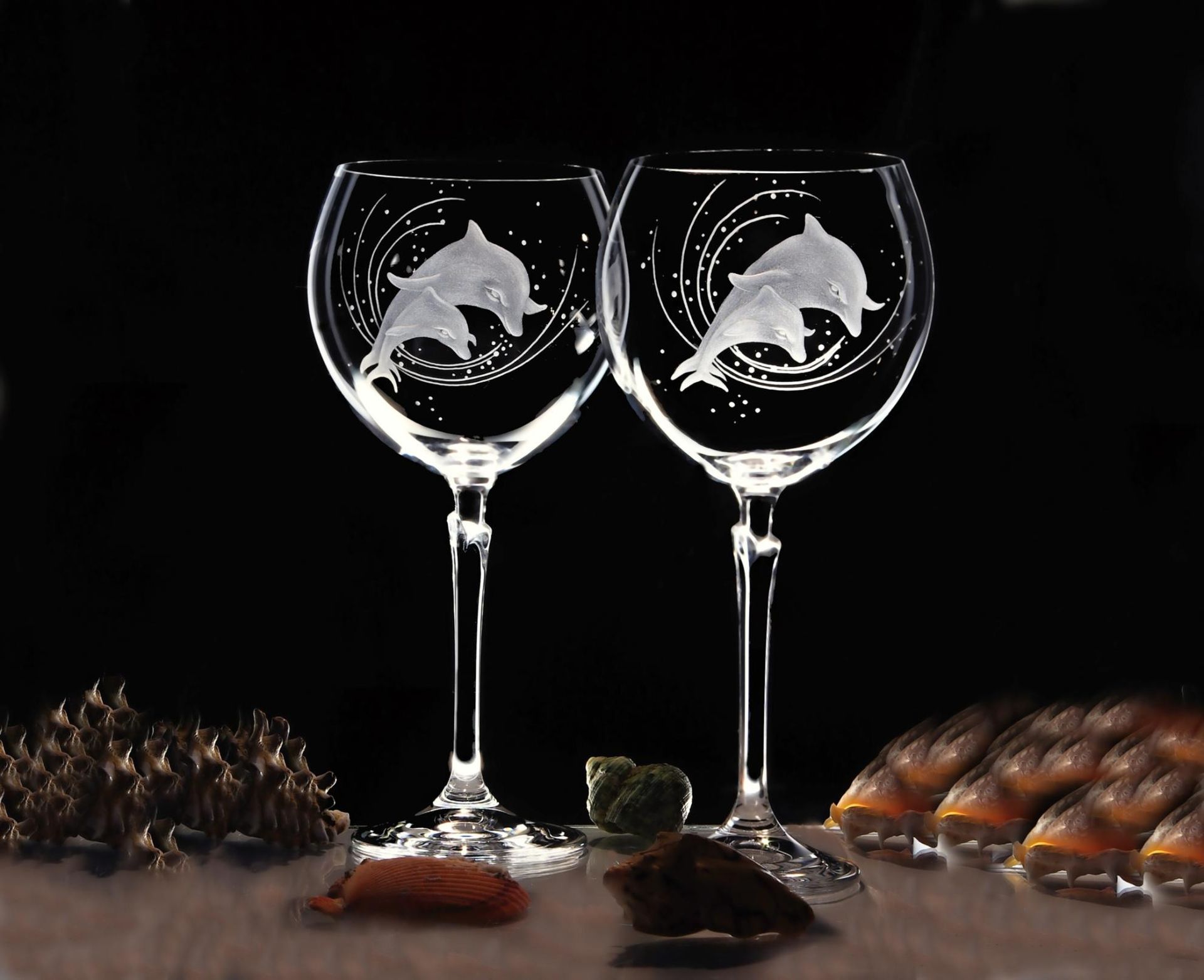 Two Wine Glasses With Dolphins on Them on a Table — Jimani Trophies & Engraving In Dapto, NSW