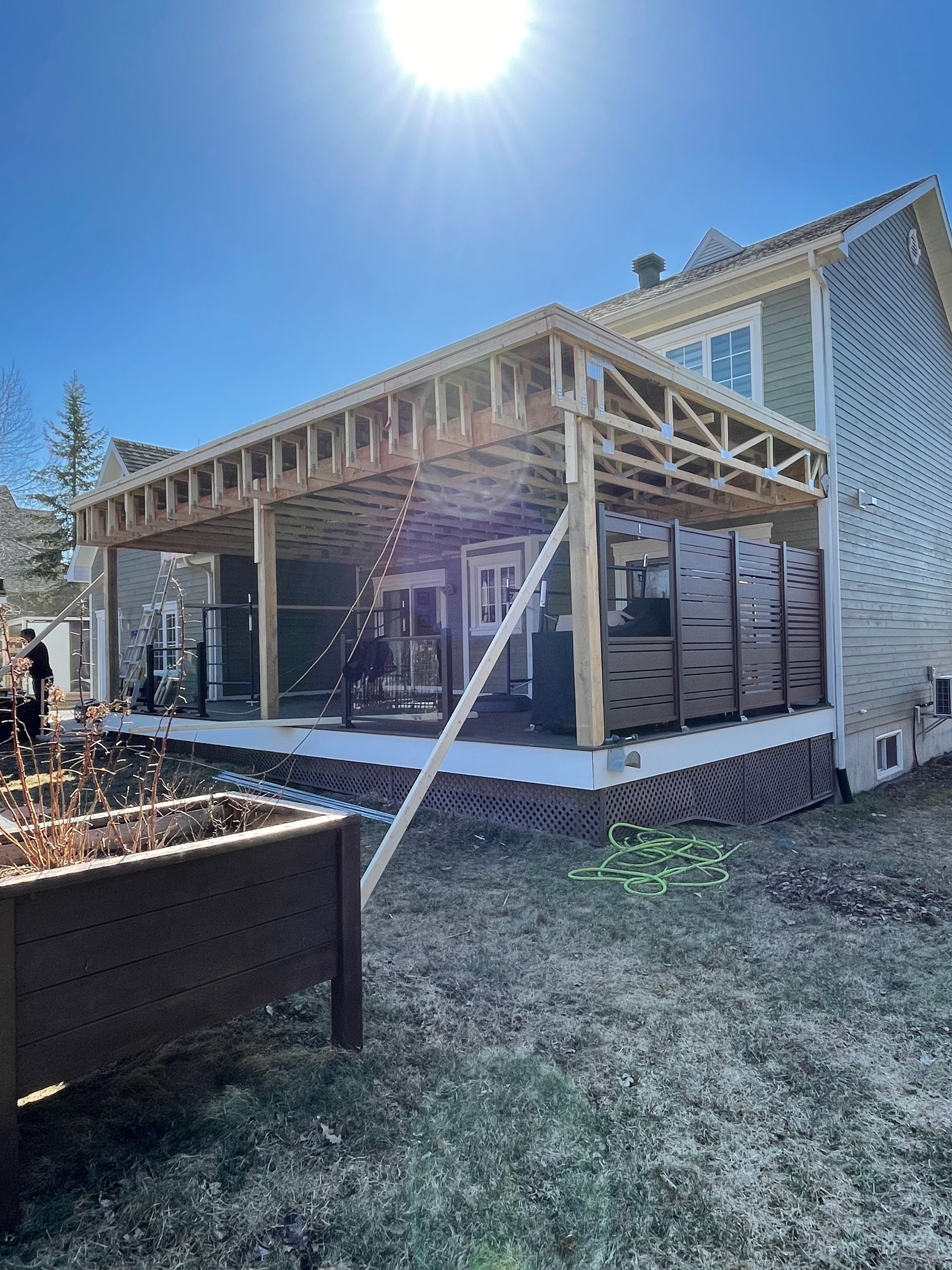 Une maison est en cours de rénovation avec un porche en construction.