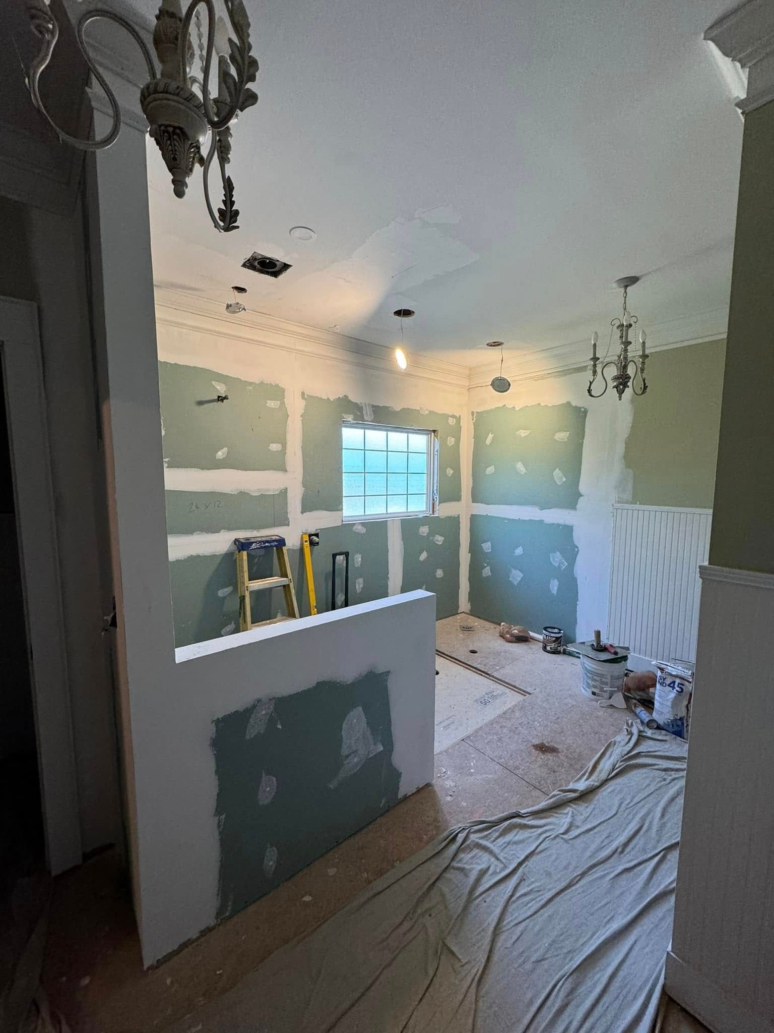 Interior room under renovation with drywall, trim, and exposed wiring.