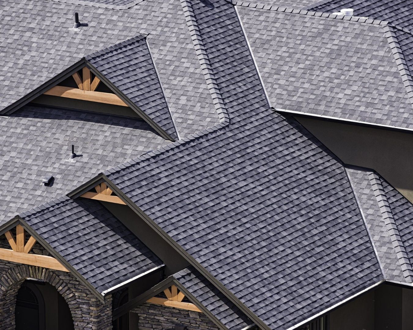An aerial view of a house with a gray roof