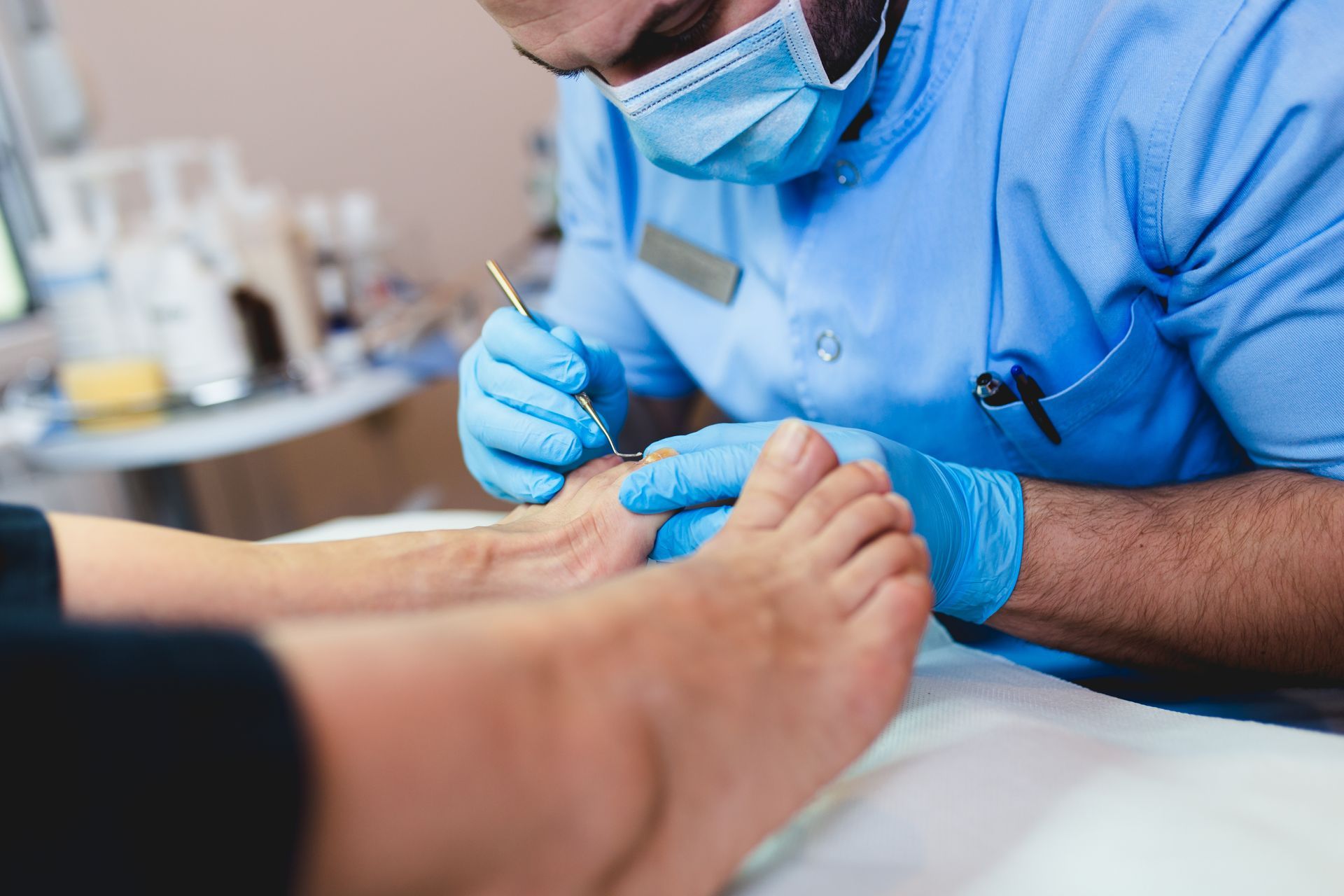 Podiatrist giving pedicure treatment to his patient.