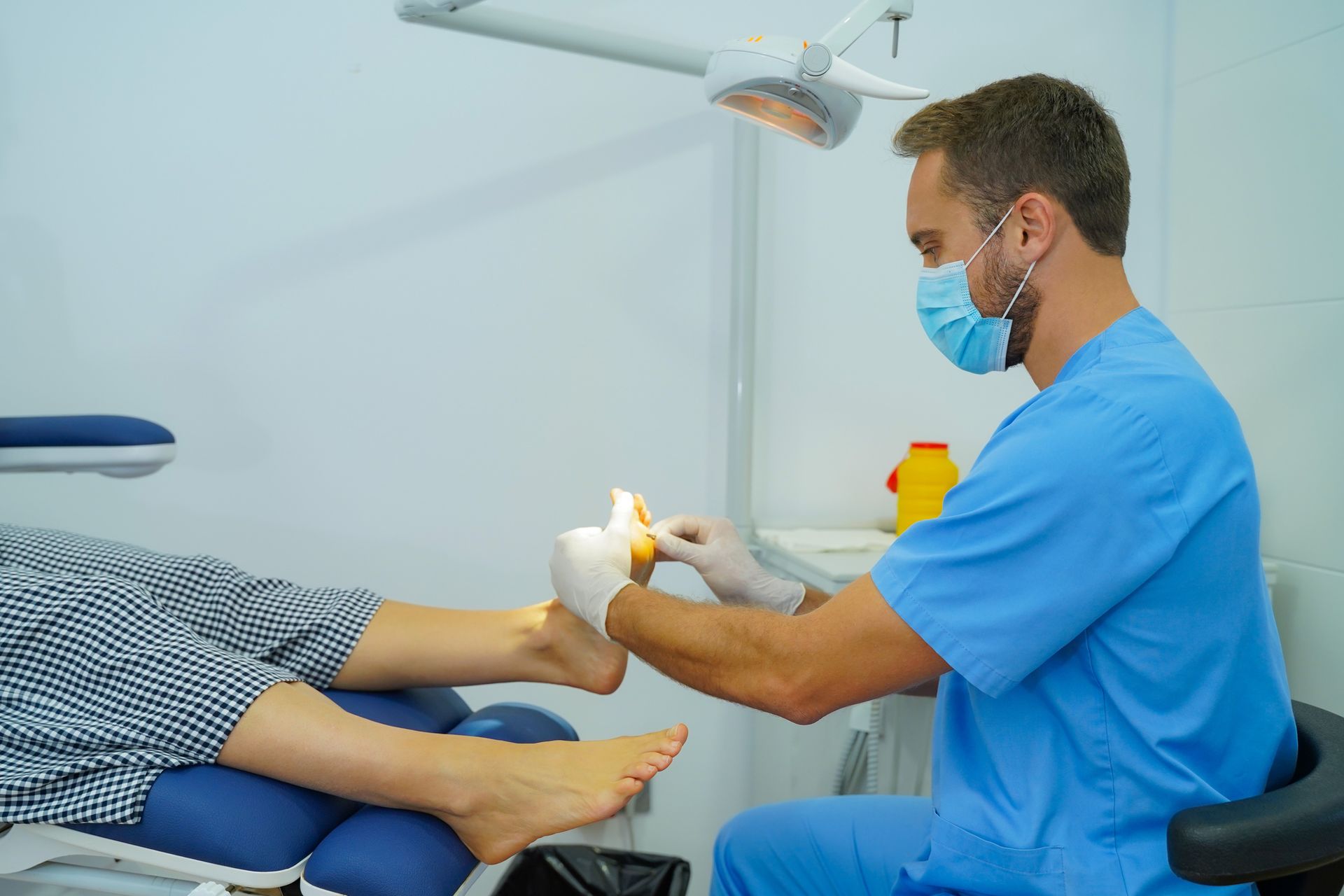 A podiatrist is checking the feet of a woman.
