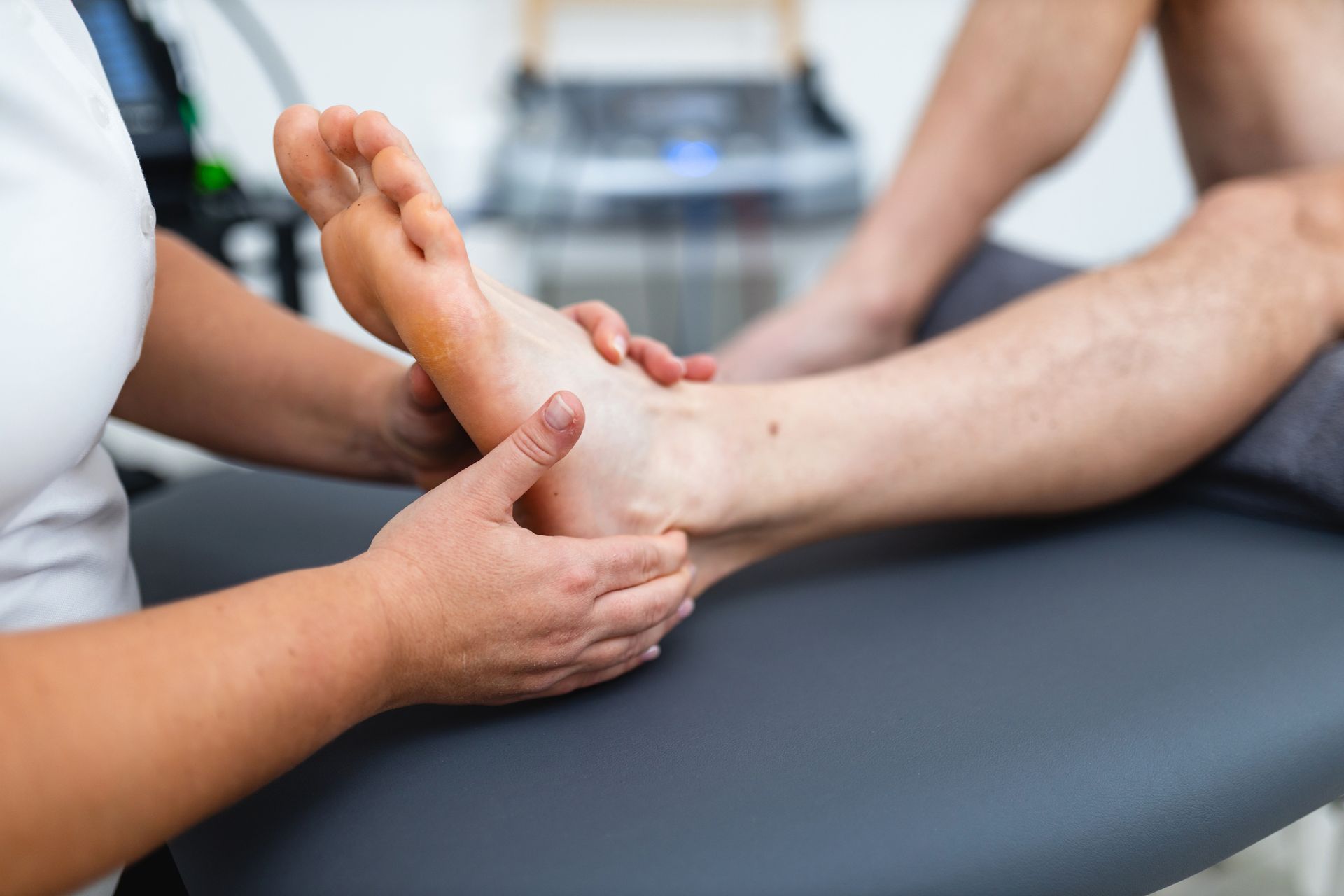 A woman is giving a foot massage to a man.