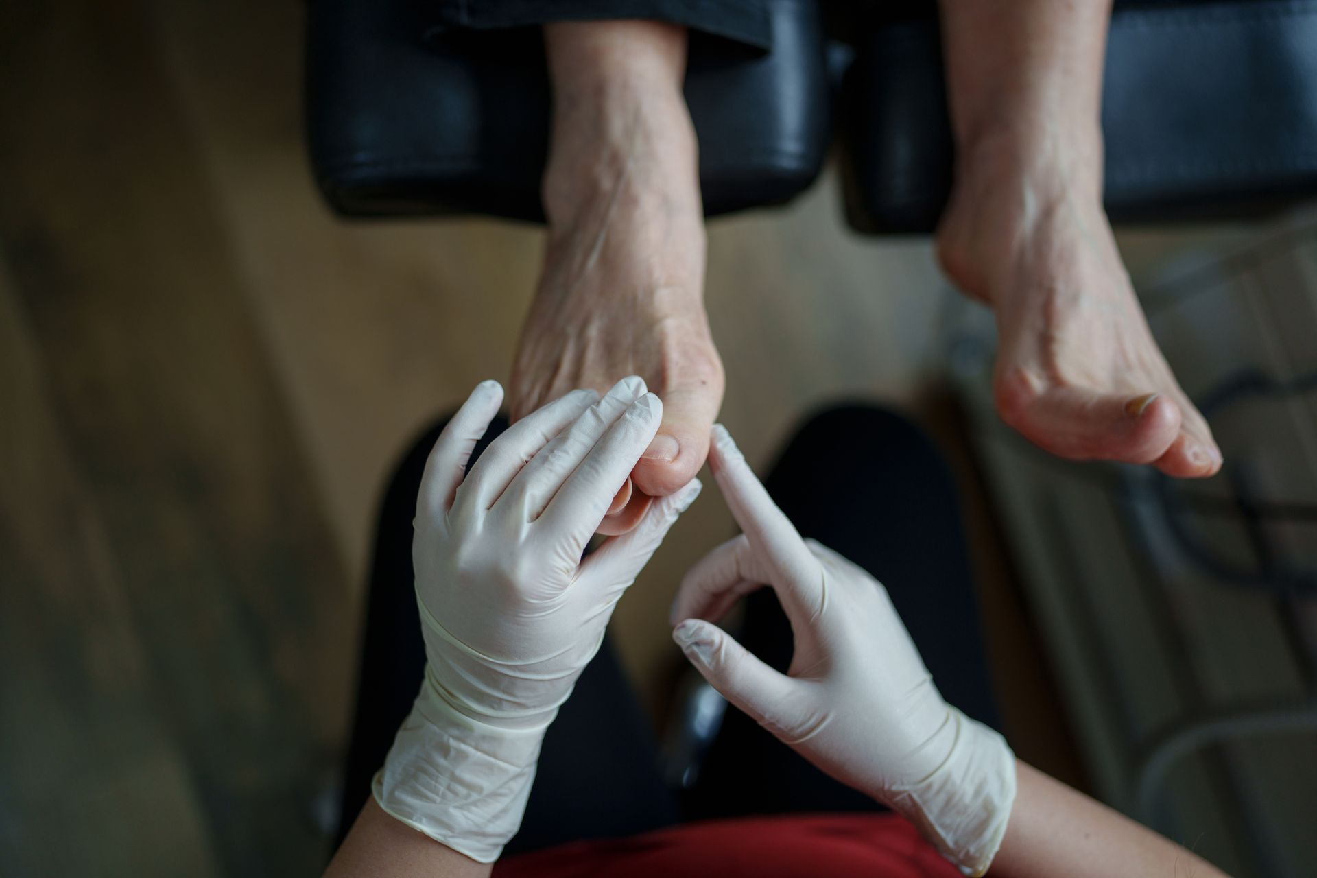 Podiatrist examining a patient's toenail fungus before recommending treatment. Podiatrist examining a patient's toenail fungus before recommending treatment.