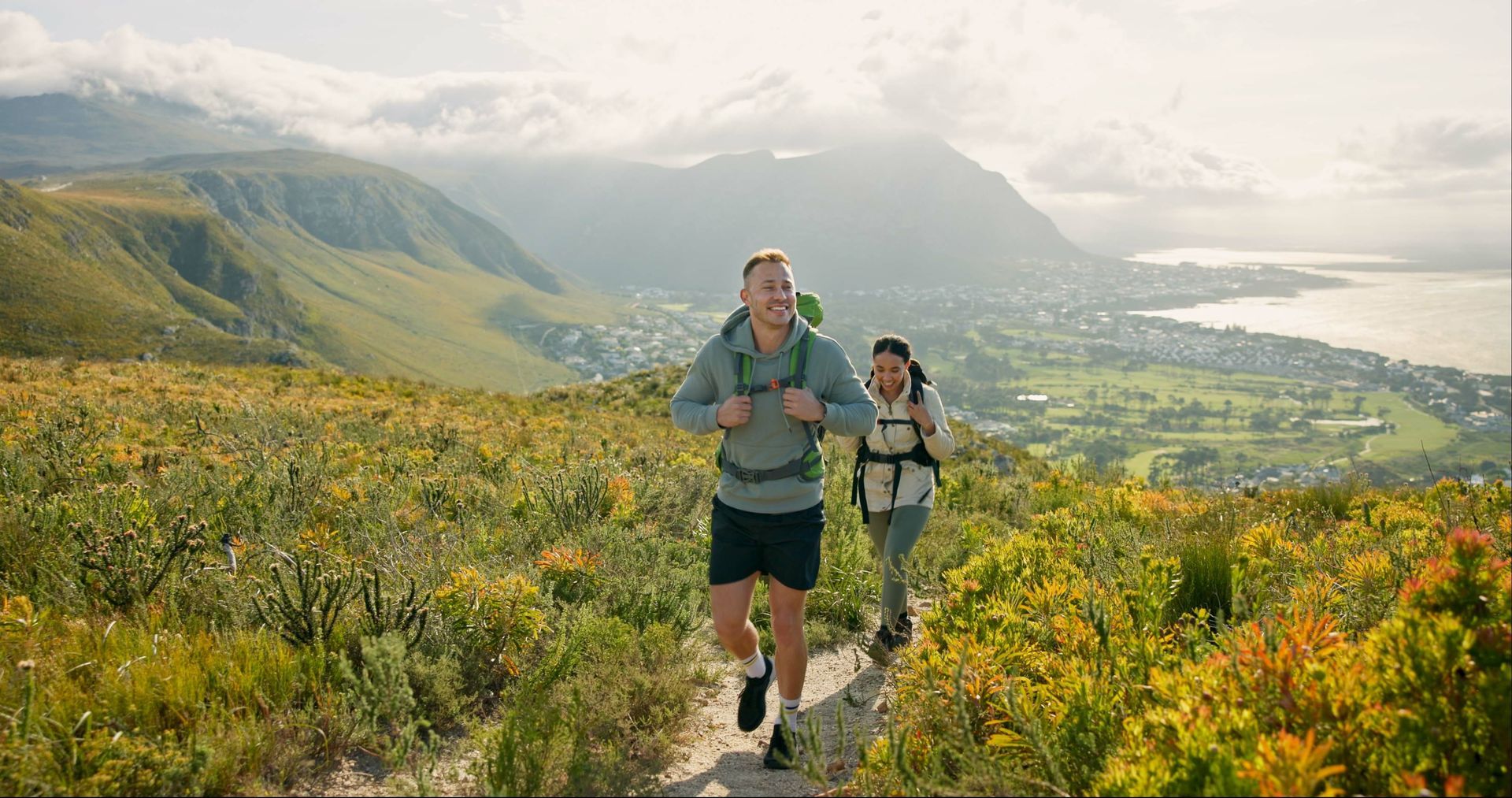 A man and a women trekking a mountain
