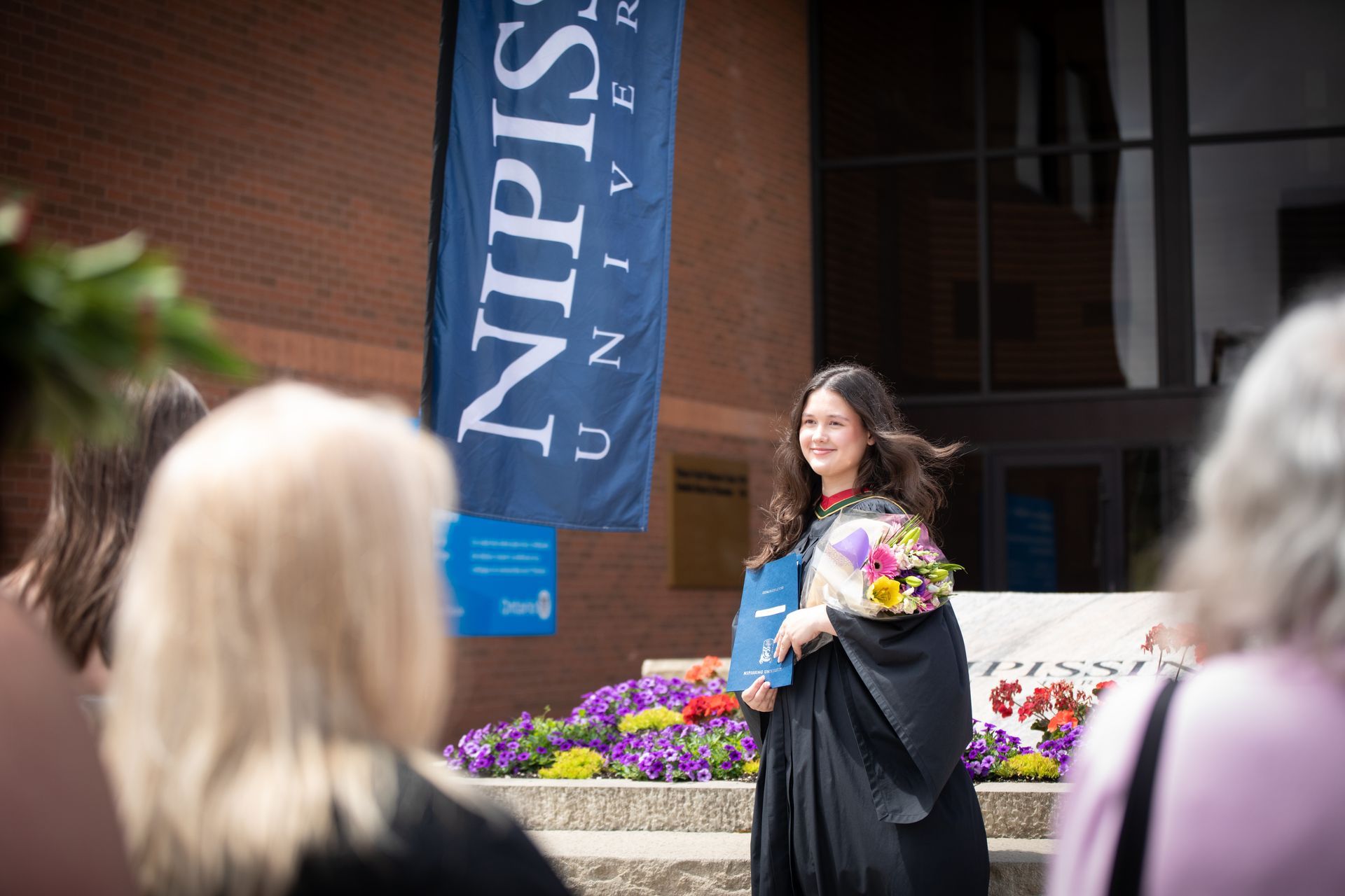 Nipissing University graduate posing for a picture