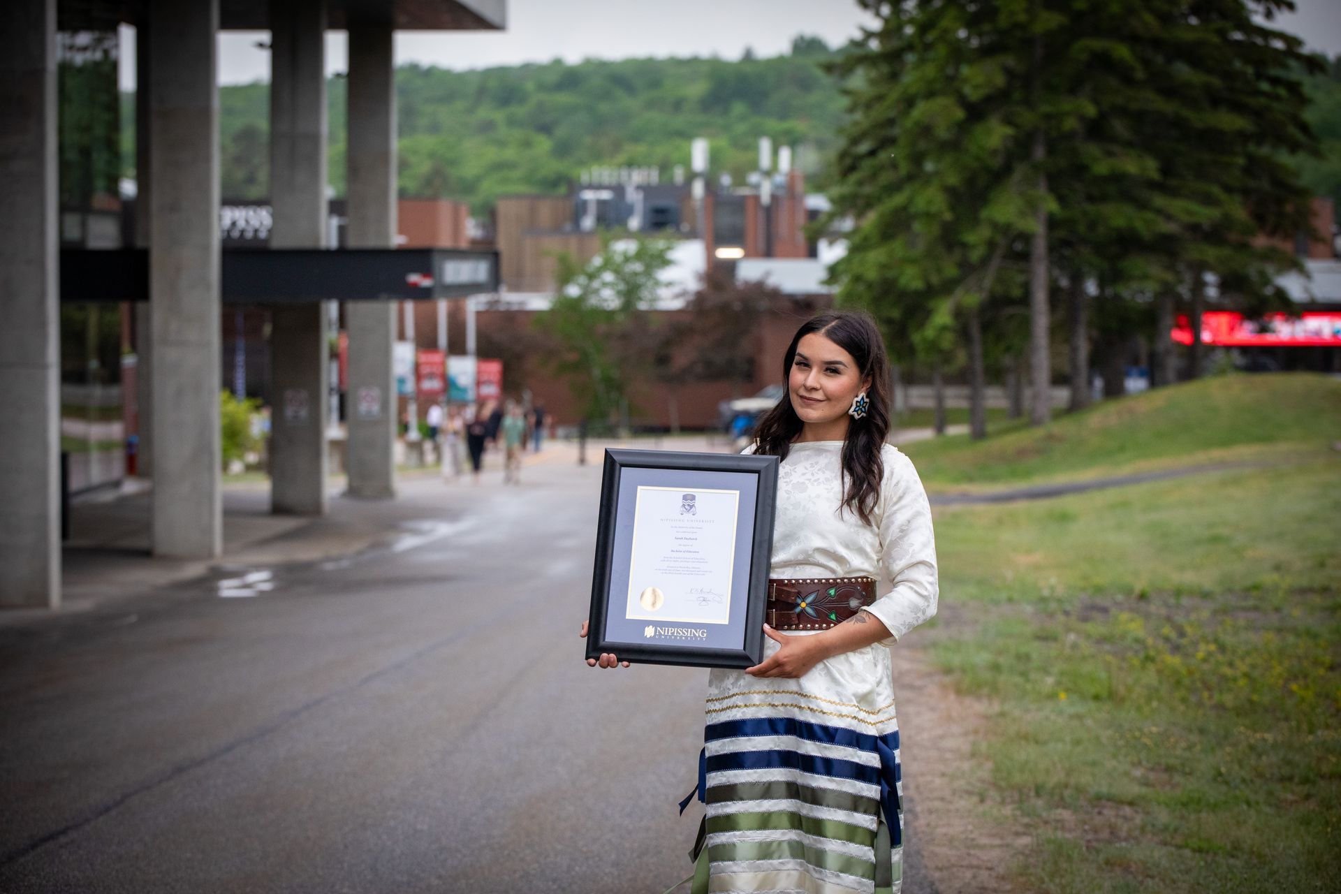 Nipissing University graduate posing for a picture