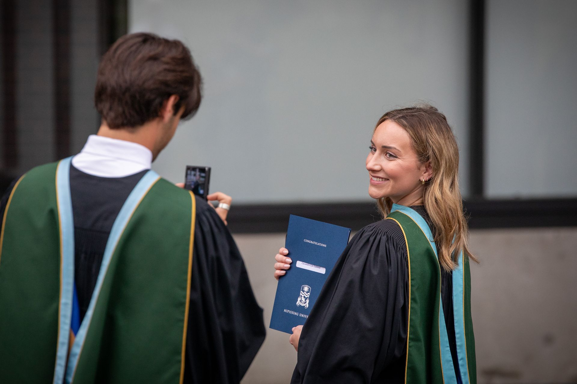 Nipissing University graduate posing for a picture