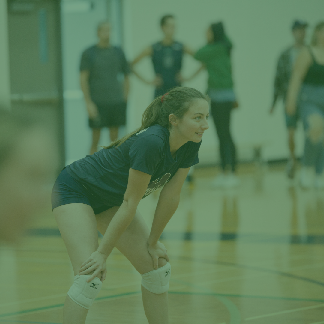 A female volleyball player preparing for her match.
