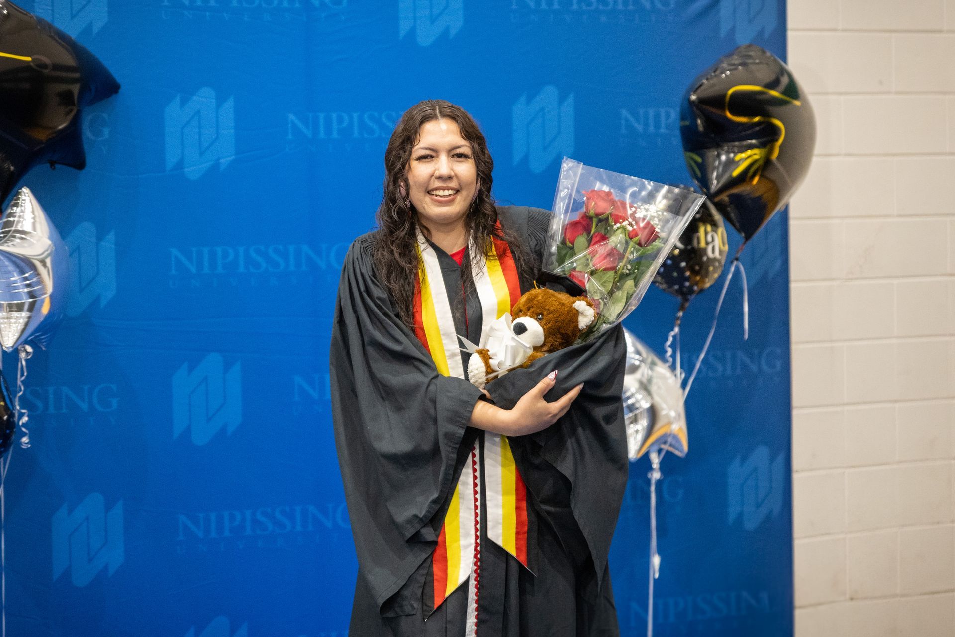Nipissing University graduate posing for a picture