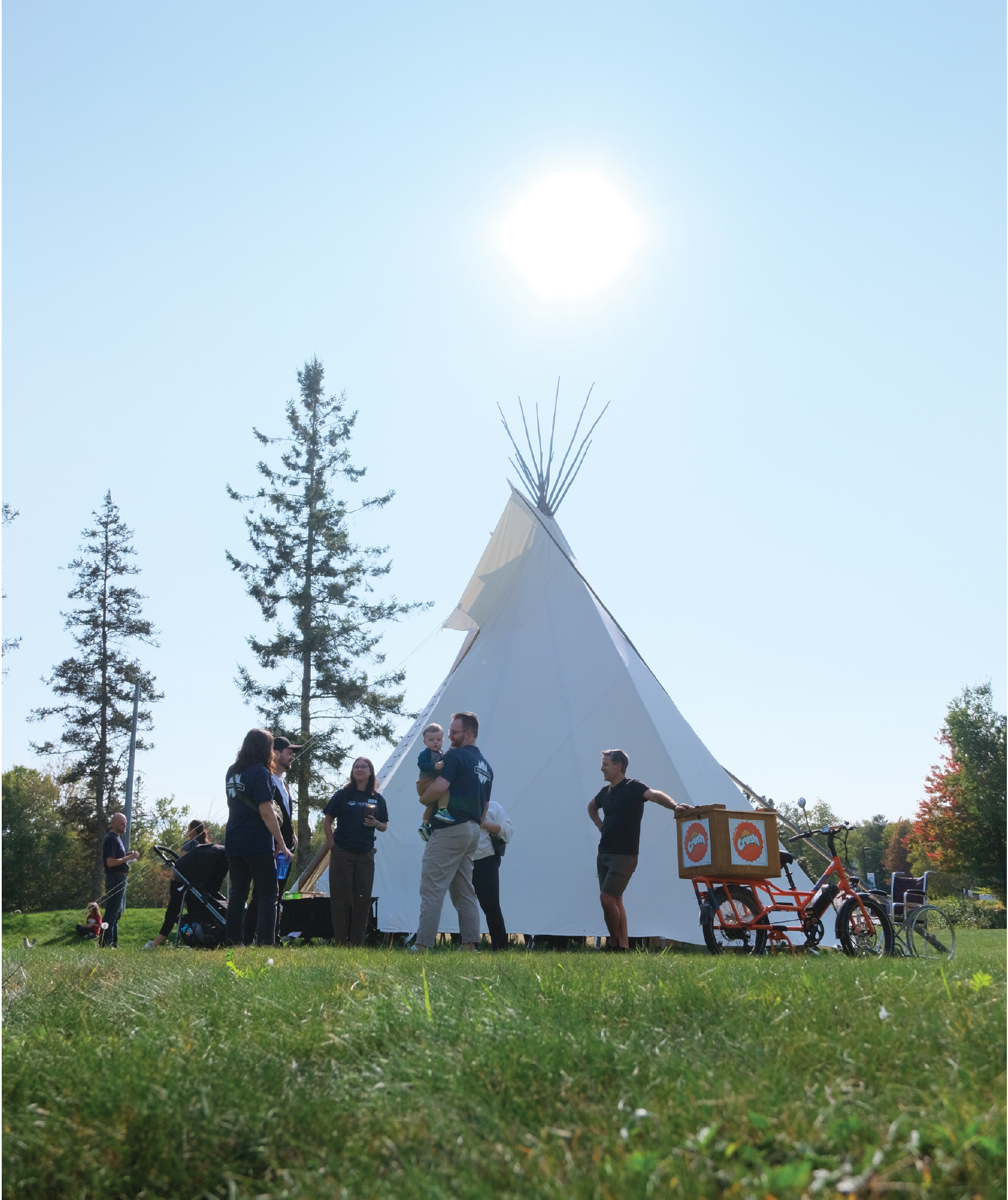 A group of people standing in front of the Tipi