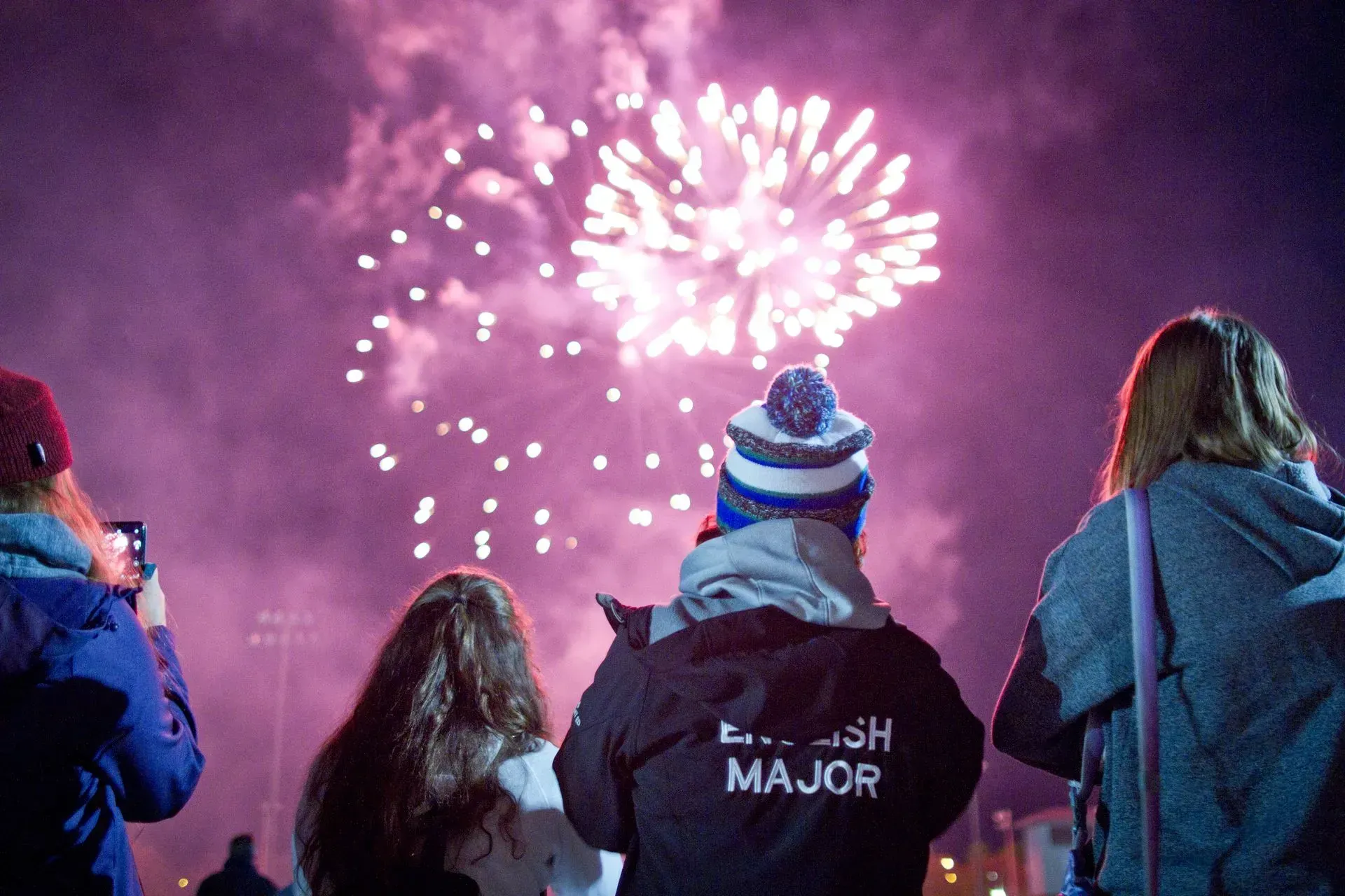 A group of people are watching a fireworks display.