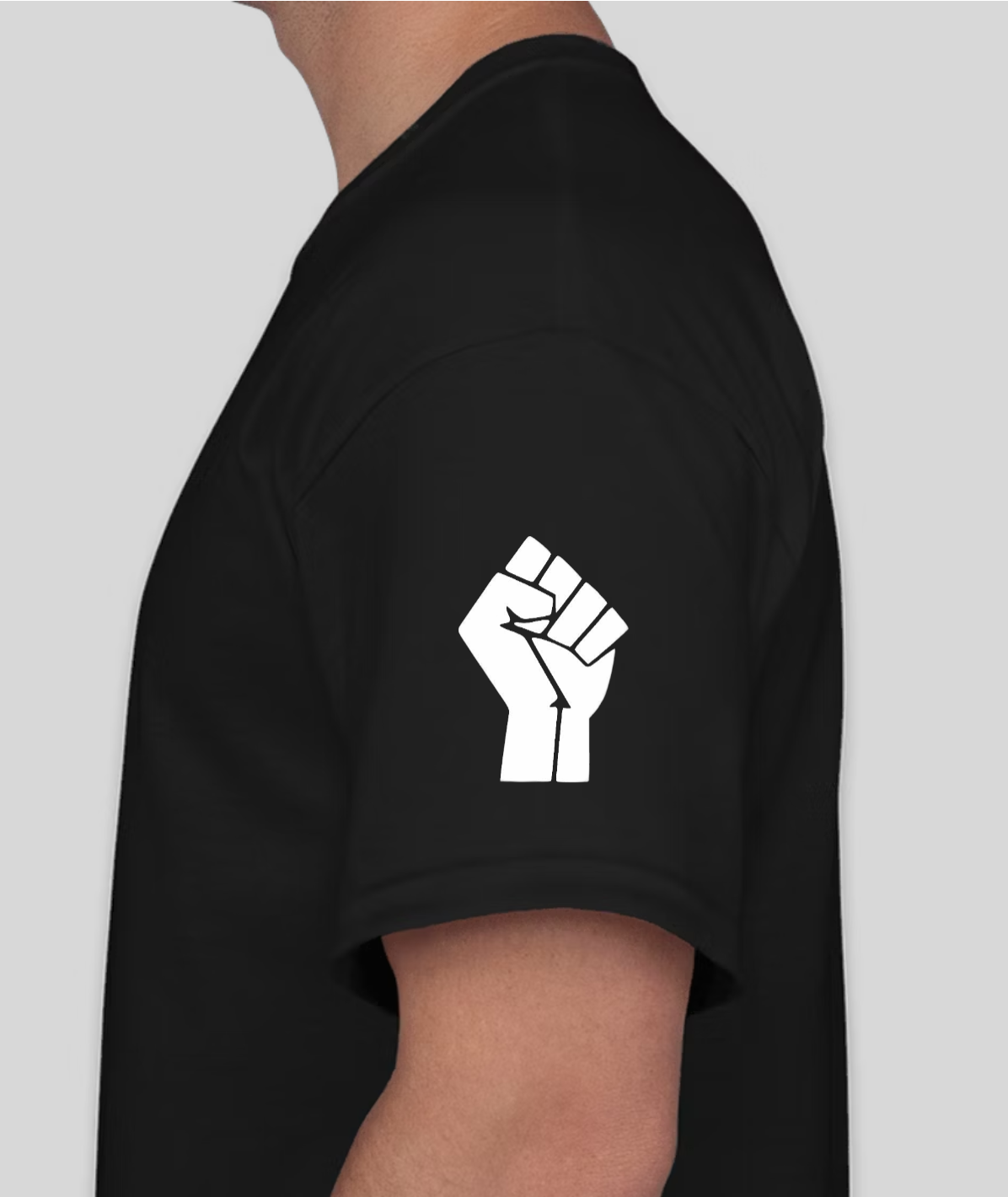 Black t-shirt with white clenched fist graphic on the left sleeve, worn by a person.