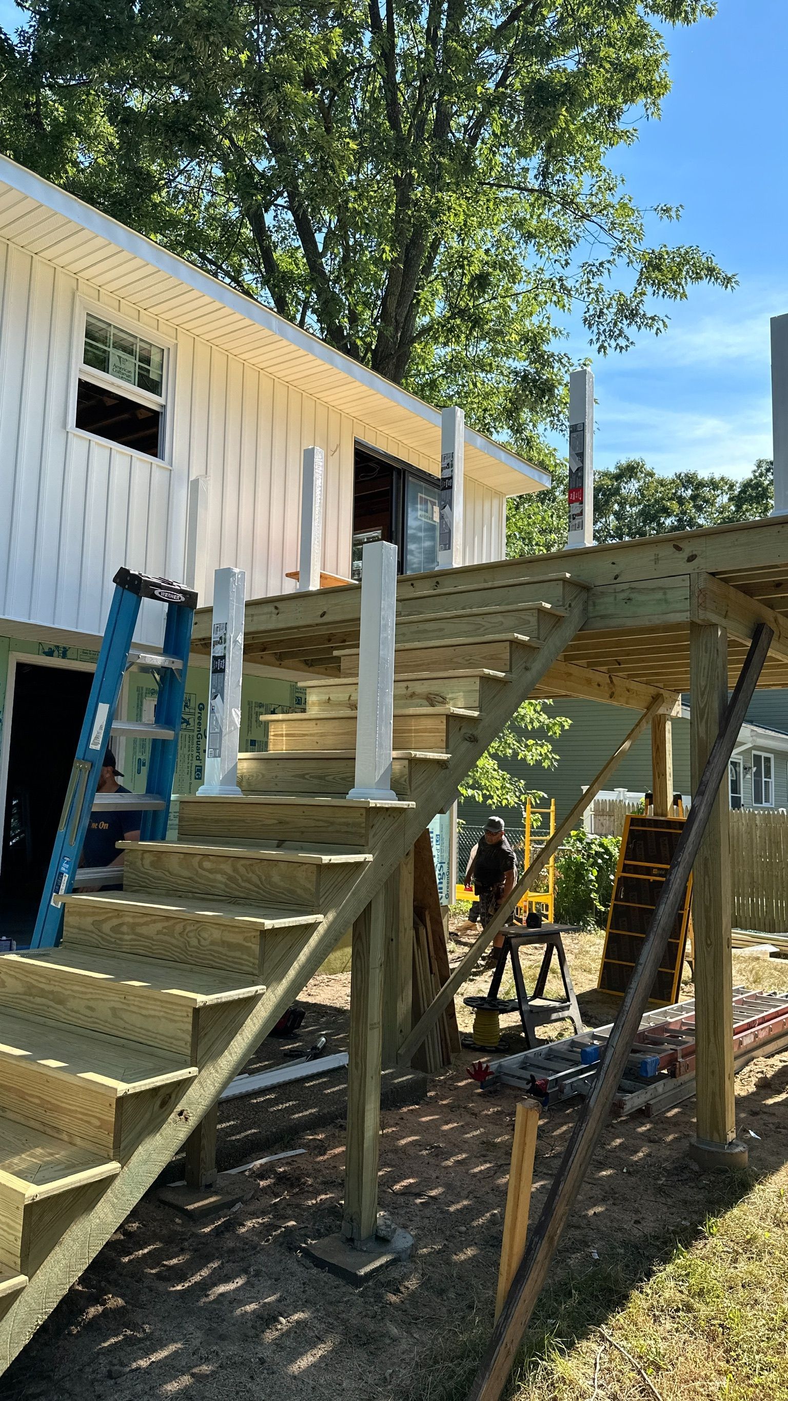 A wooden deck is being built on top of a house.