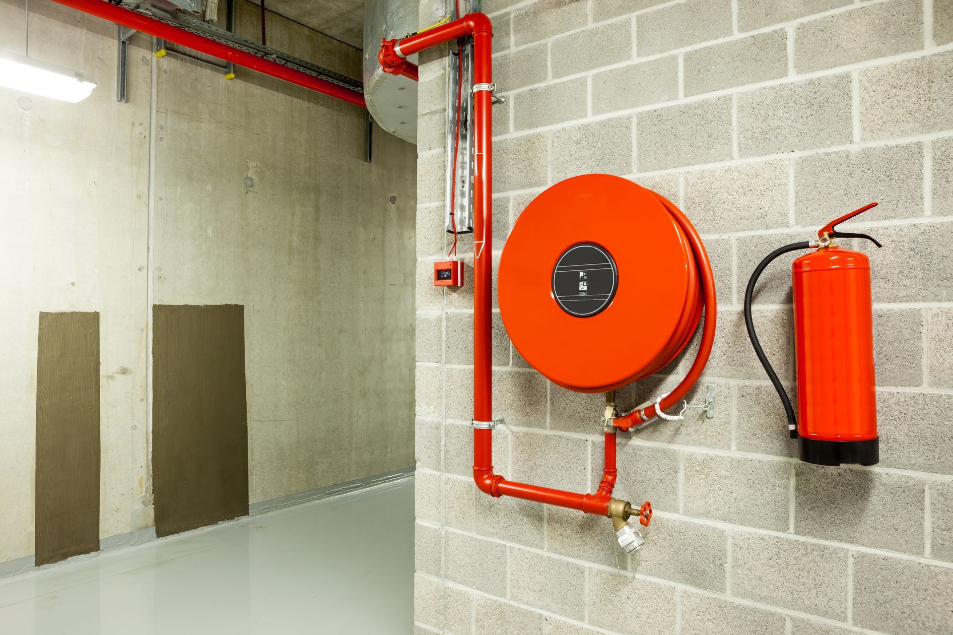 Fire extinguisher and fire hose reel on the wall Fire extinguisher and fire hose reel on the wall