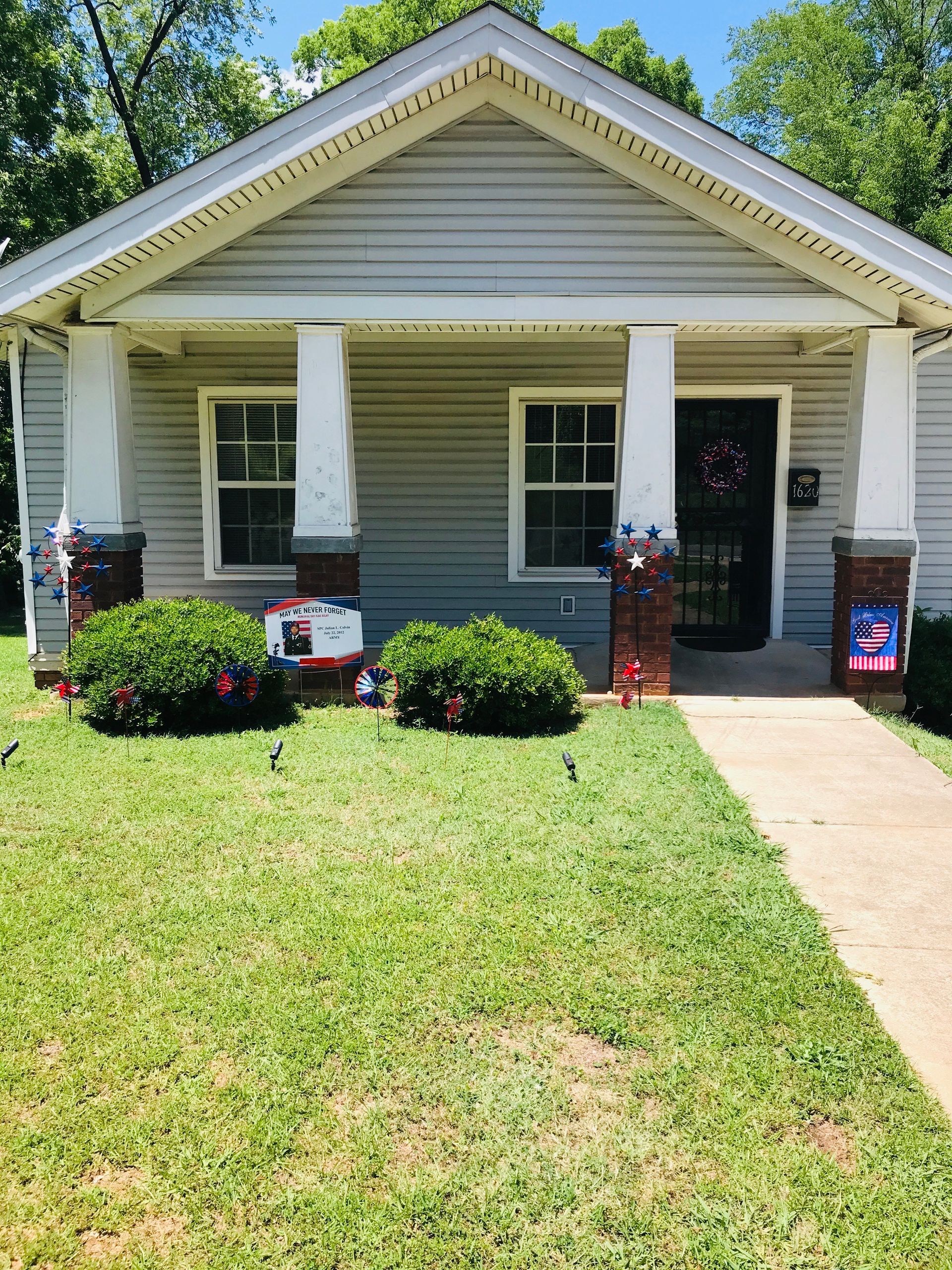 A house with a lush green lawn in front of it.