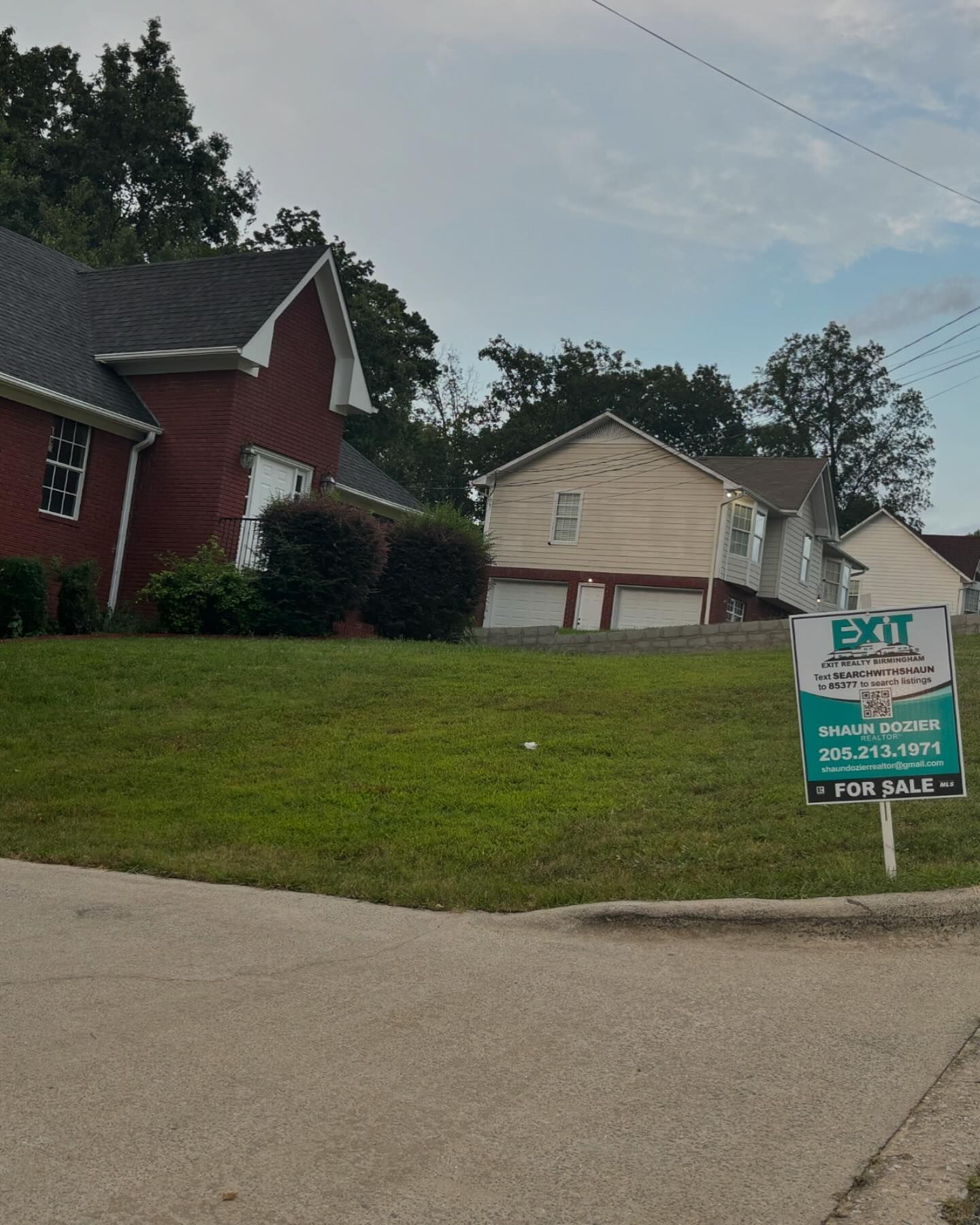 A for sale sign in front of a house