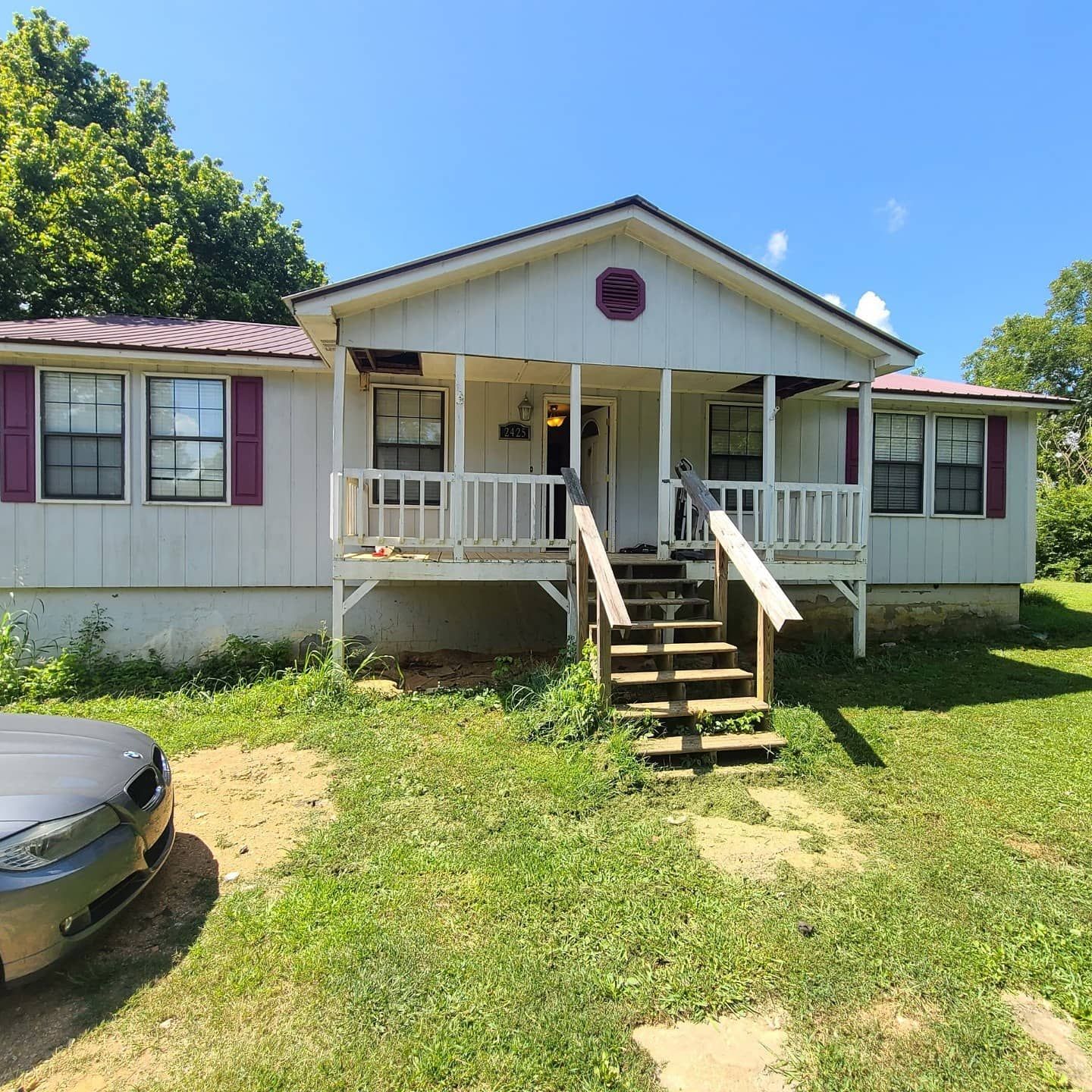 A house with a car parked in front of it