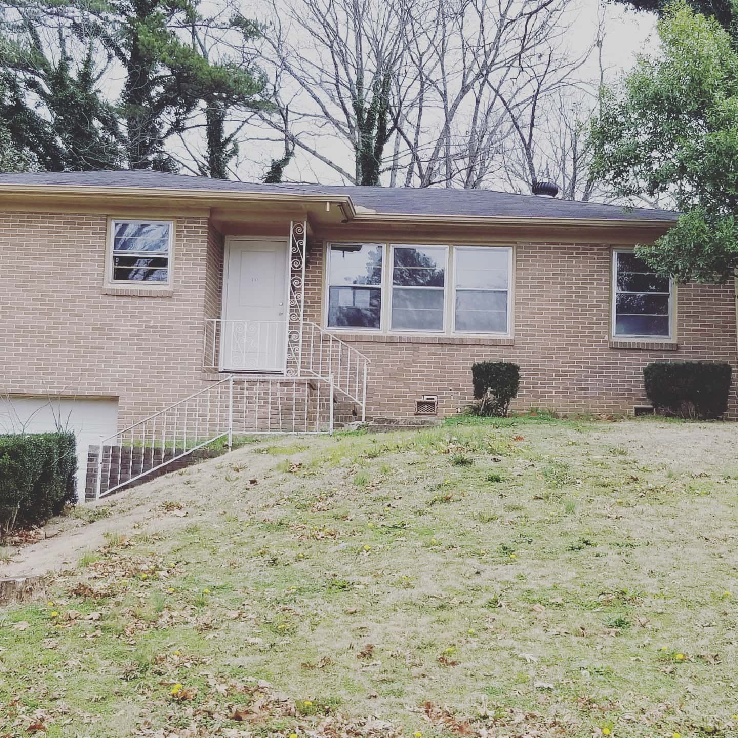 A brick house with a white door and stairs