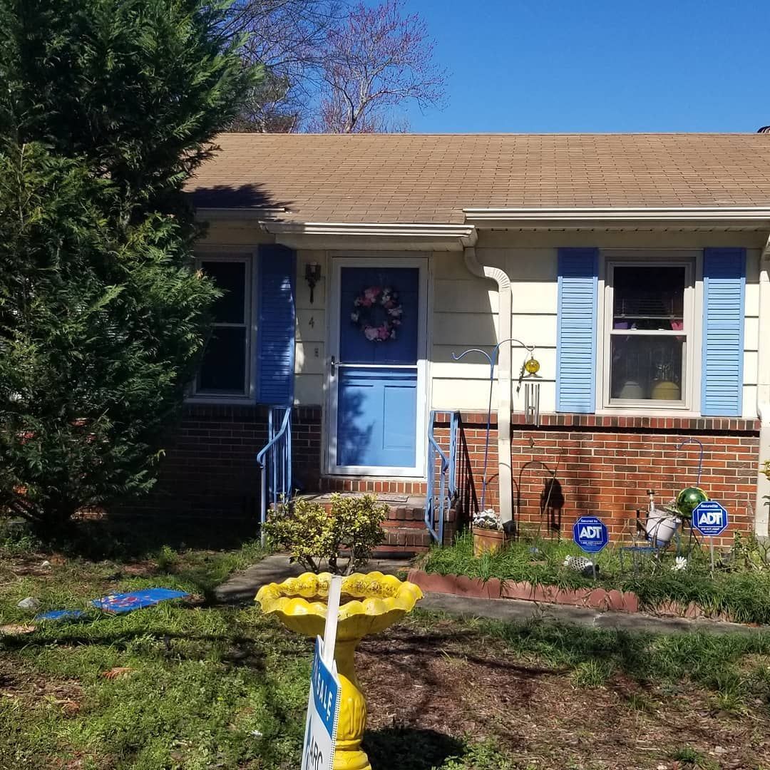 A house with a blue door and blue shutters