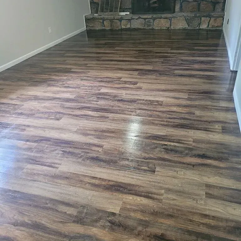 A living room with hardwood floors and a fireplace.