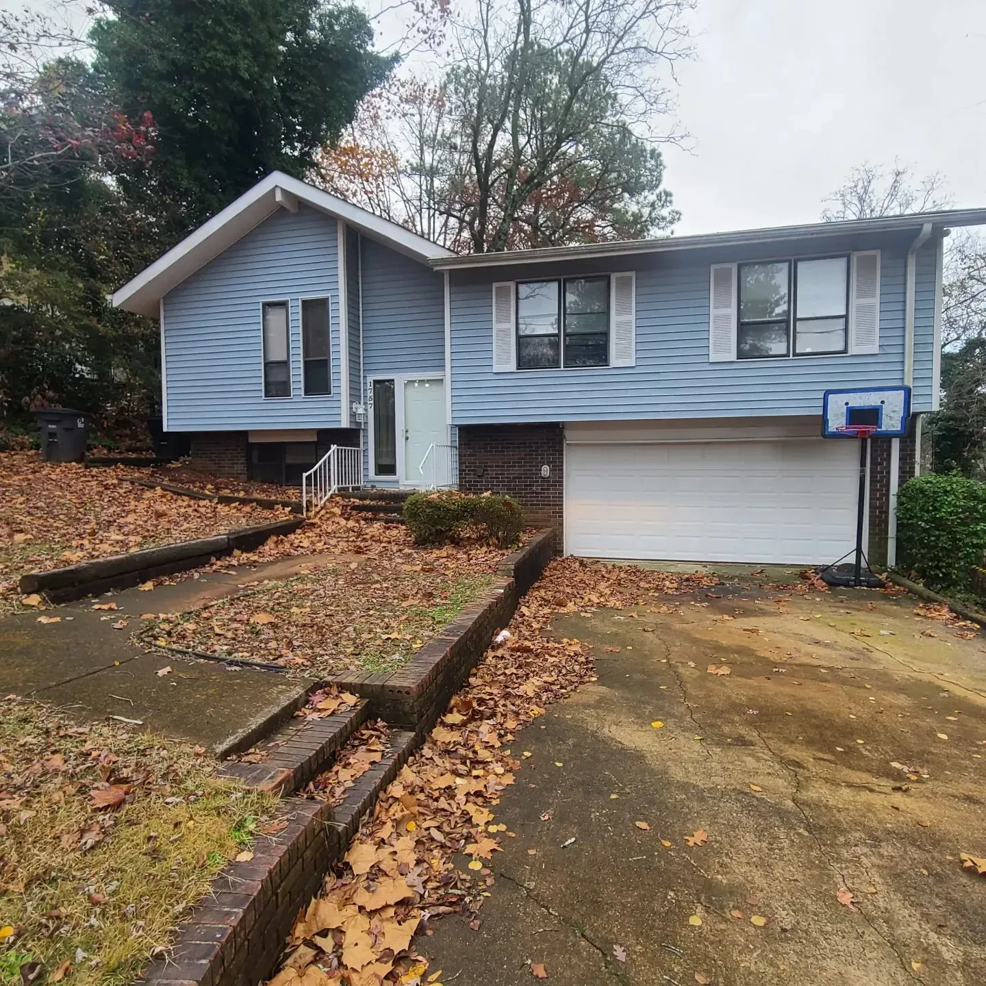 A house with a basketball hoop in front of it