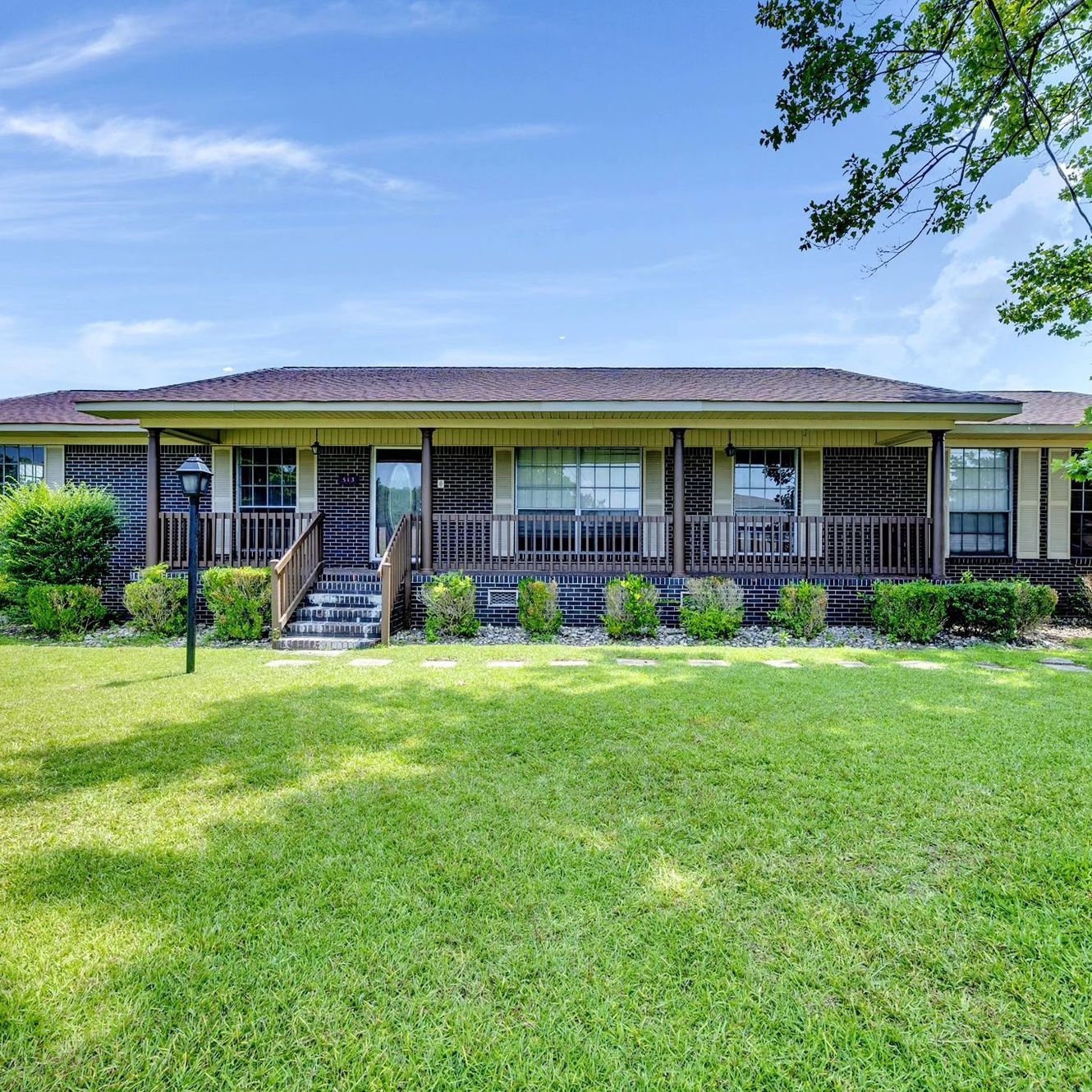 A large house with a large lawn in front of it.