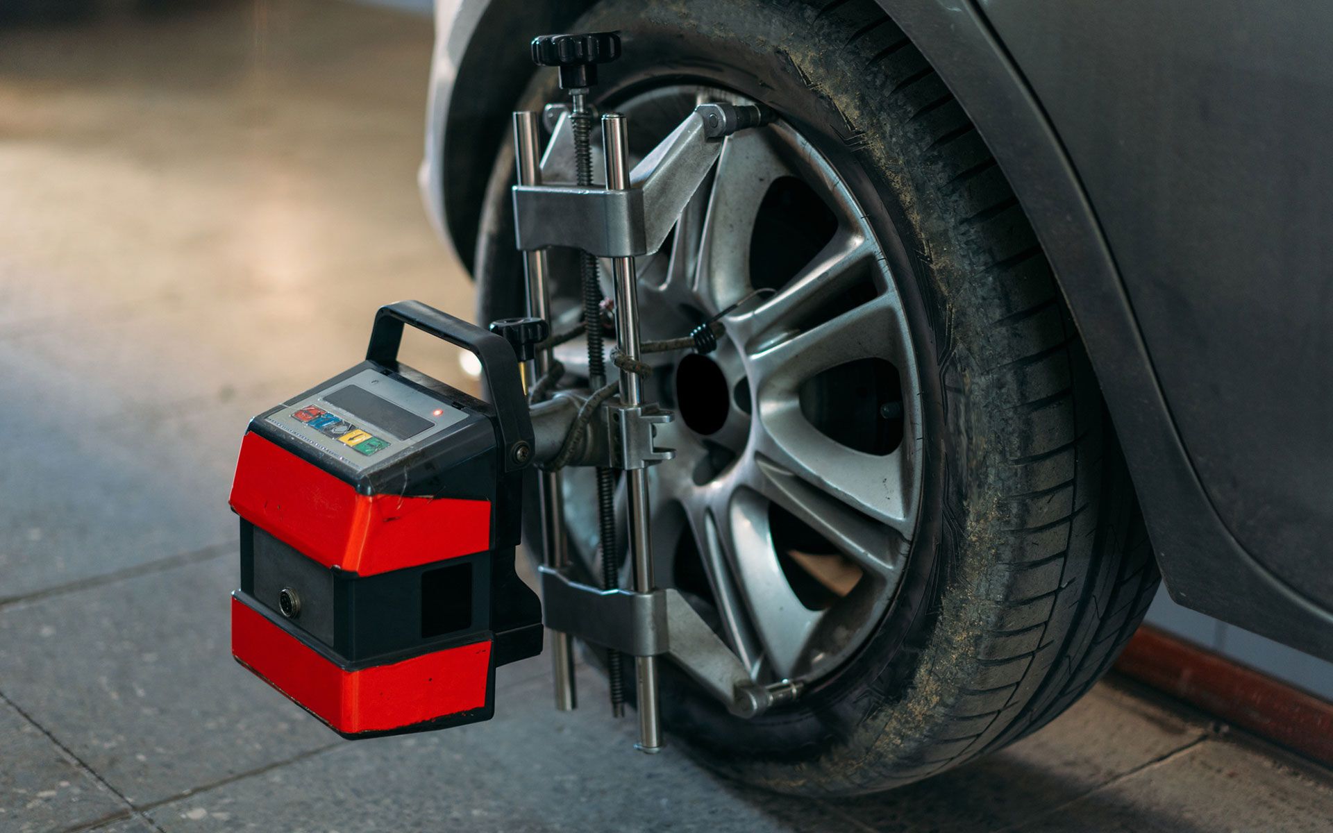 A car wheel is being aligned with a machine.