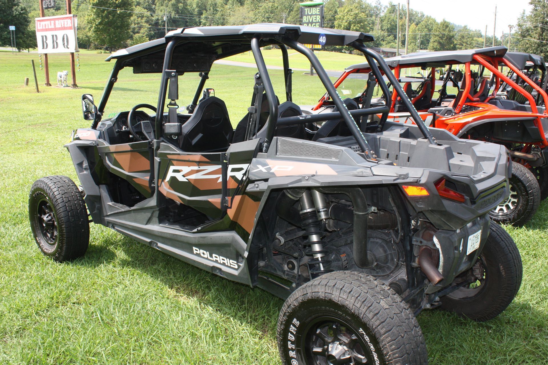 A row of atvs are parked in a grassy field.