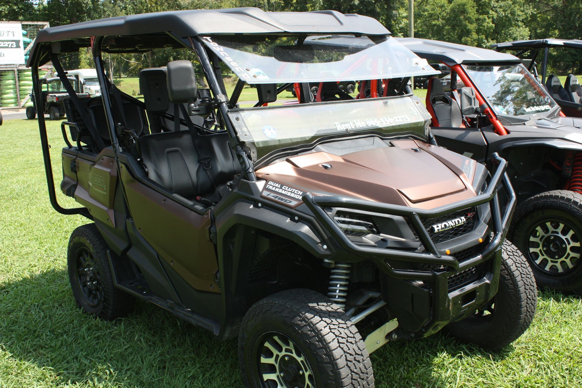A group of atvs are parked in a grassy field.